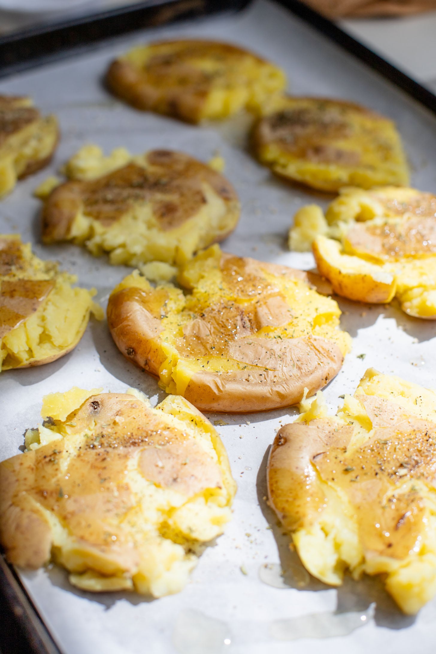 This Vegan Smashed Potato Salad is made with Yukon gold potatoes that are crisped up in the oven and tossed in a dairy-free dressing | ThisSavoryVegan.com