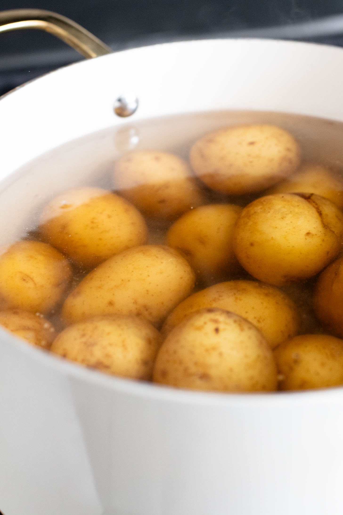 This Vegan Smashed Potato Salad is made with Yukon gold potatoes that are crisped up in the oven and tossed in a dairy-free dressing | ThisSavoryVegan.com