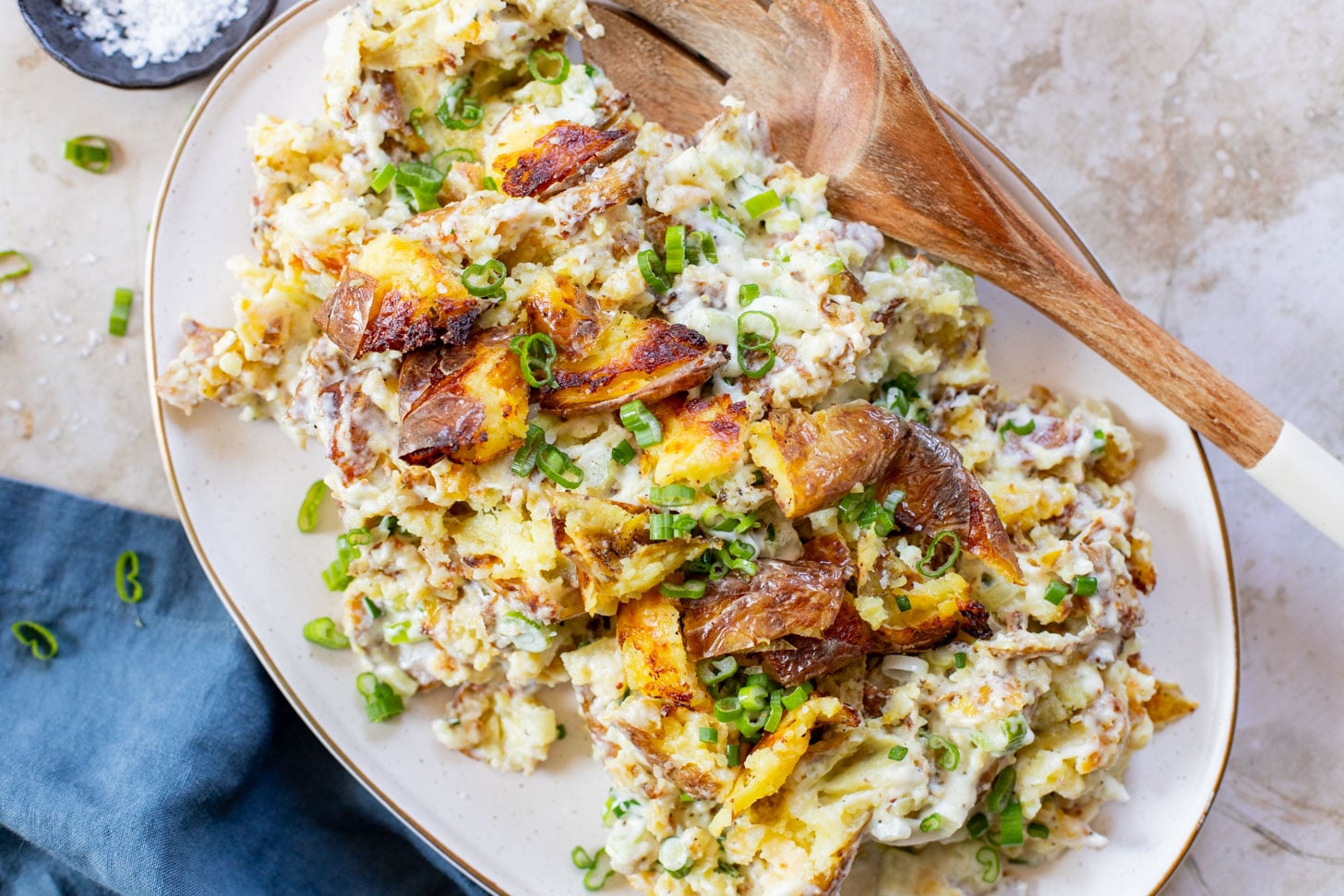 This Vegan Smashed Potato Salad is made with Yukon gold potatoes that are crisped up in the oven and tossed in a dairy-free dressing | ThisSavoryVegan.com