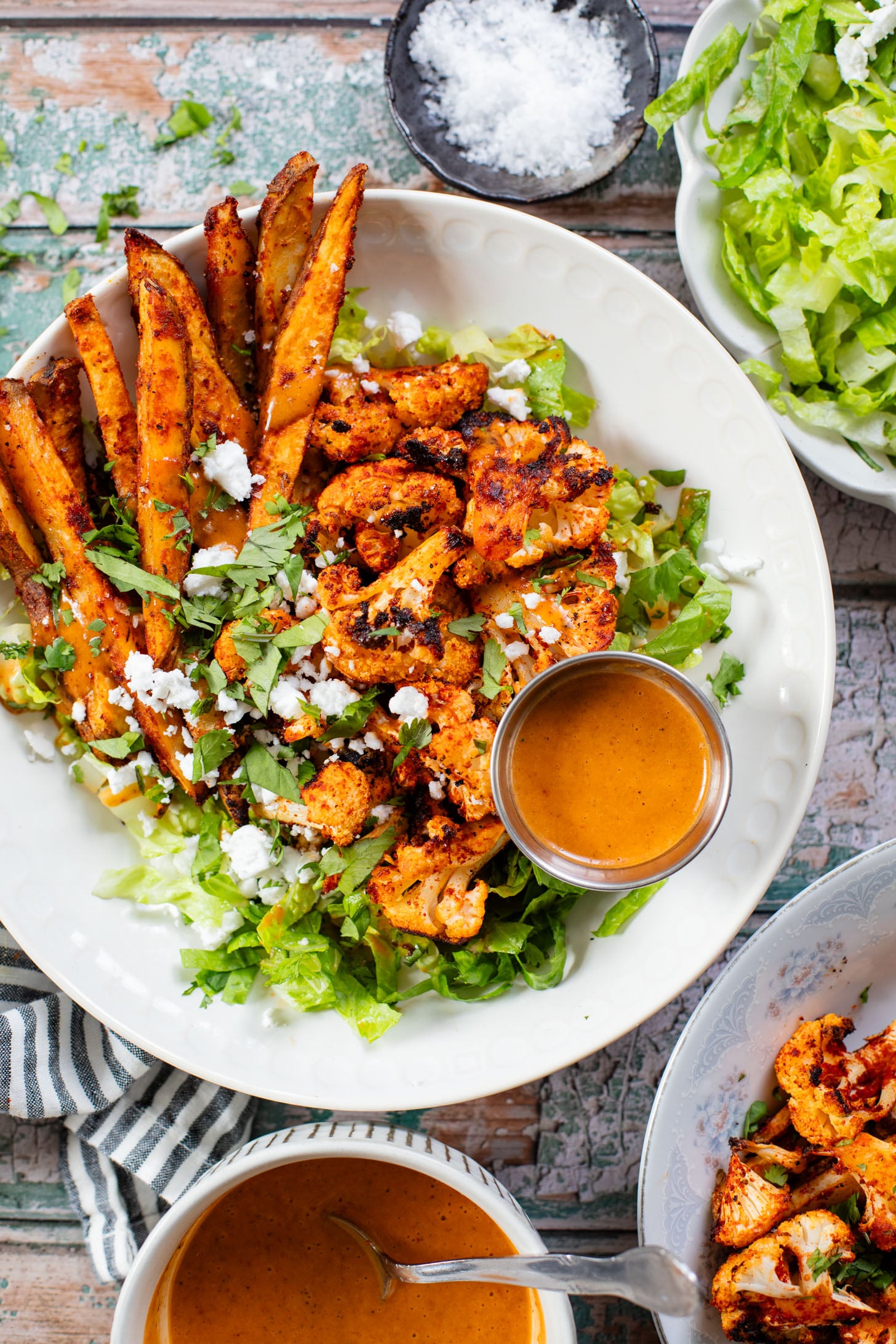These Roasted Cauliflower & Potato Bowls are layered with seasoned roasted veggies, fresh romaine & a chipotle agave vinaigrette | ThisSavoryVegan.com