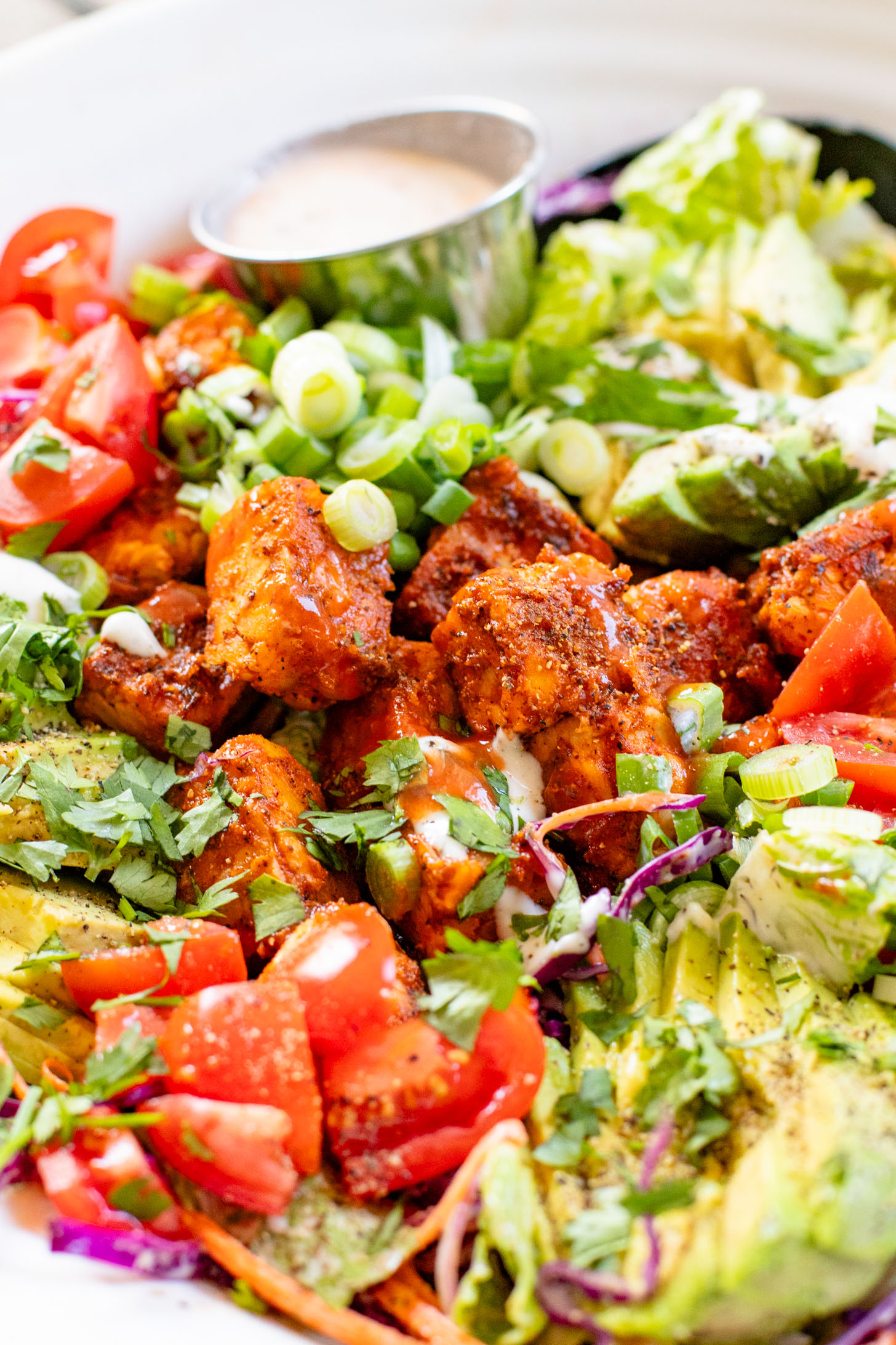 Loaded with crispy buffalo tempeh, vegan ranch and all the crunchy veggies, this Buffalo Tempeh Salad is a healthy, simple and delicious vegan salad | ThisSavoryVegan.com
