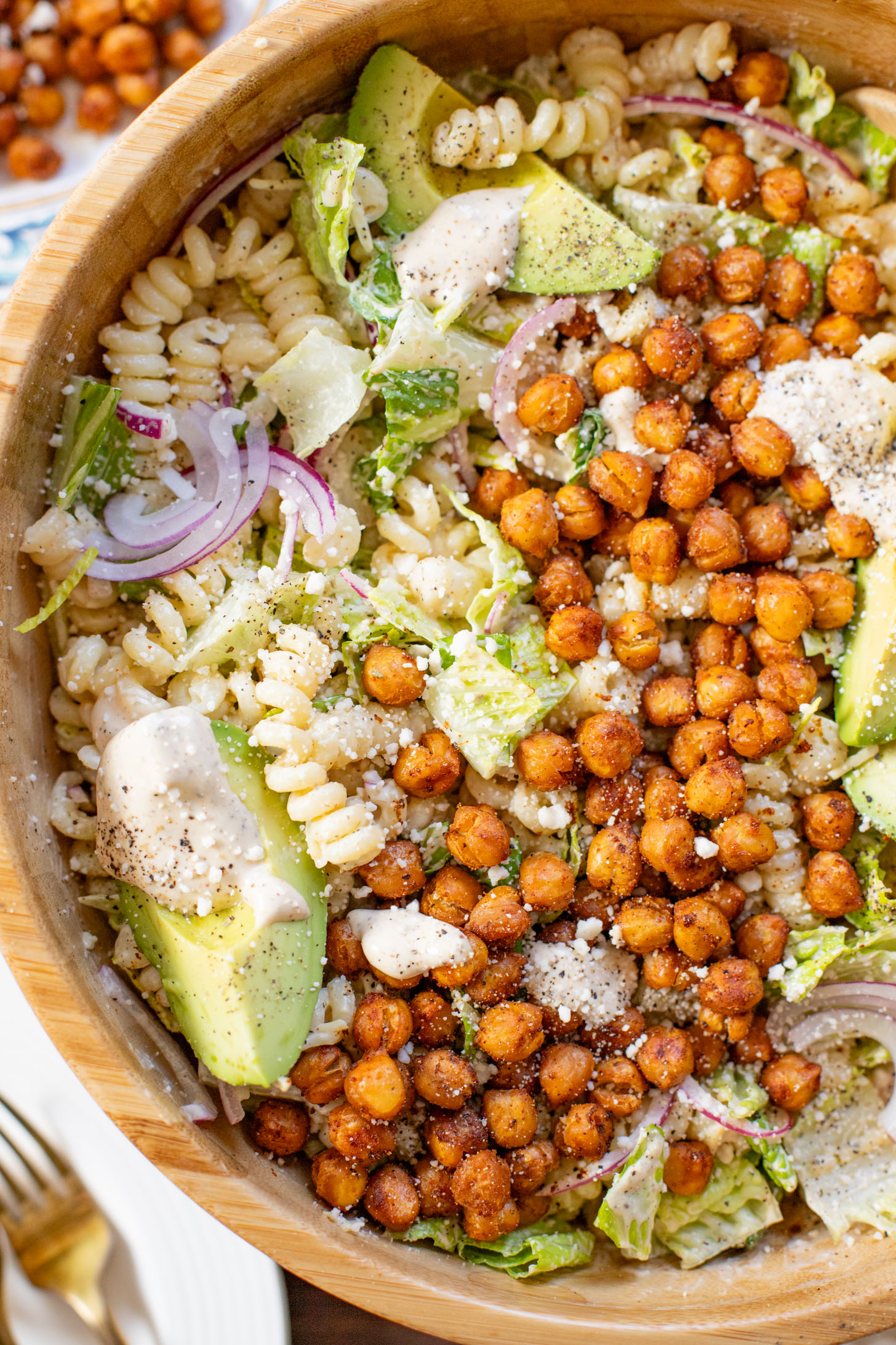 Zesty & delicious, this Cajun Caesar Pasta Salad is made with dairy-free caesar dressing, crispy chickpeas, romaine, avocado & fusilli pasta | ThisSavoryVegan.com