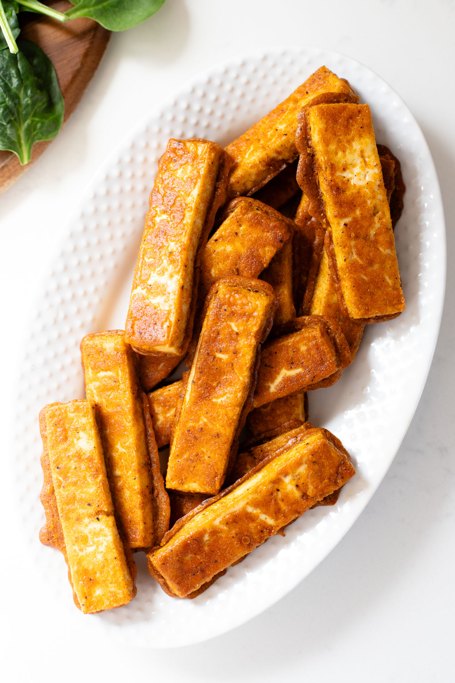 These Cajun Tofu Wraps are filled with baked cajun tofu, veggies and a dairy-free lemon pepper aioli. A great lunch or quick dinner | ThisSavoryVegan.com