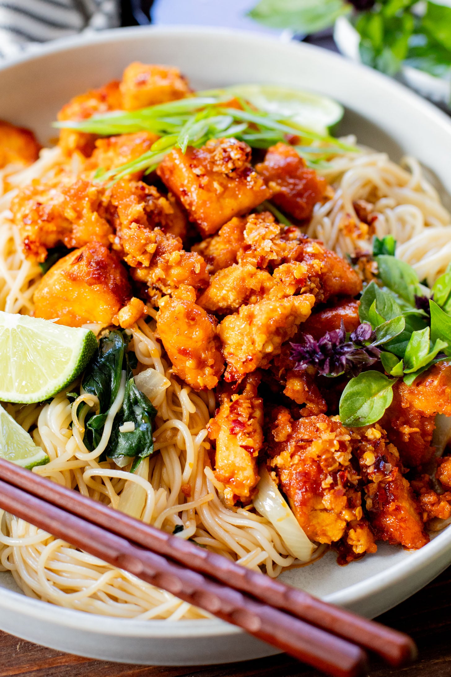 This Chili Crunch Tofu & Spinach Rice Noodles recipe is a better than takeout vegan dinner! Crispy tofu, veggie rice noodles & fresh herbs | ThisSavoryVegan.com