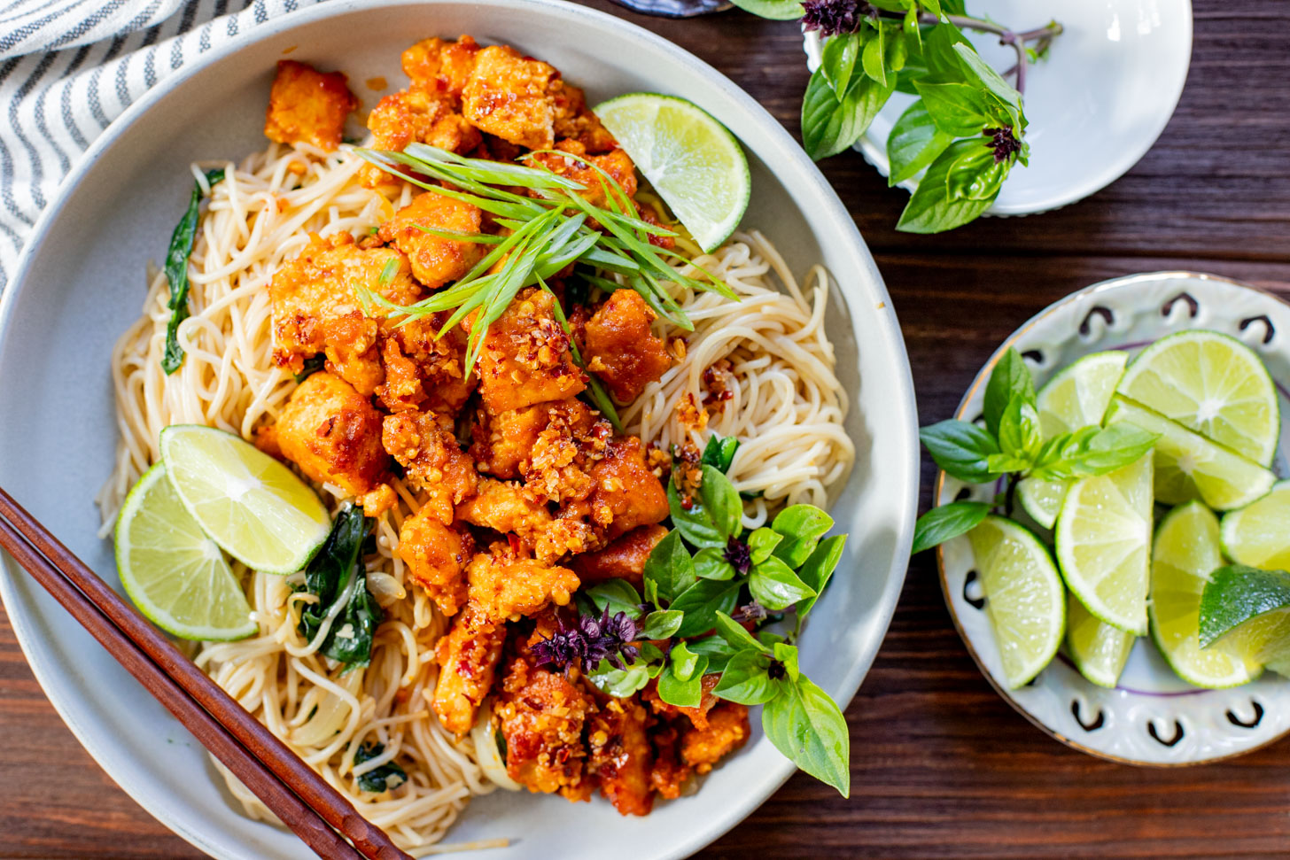 This Chili Crunch Tofu & Spinach Rice Noodles recipe is a better than takeout vegan dinner! Crispy tofu, veggie rice noodles & fresh herbs | ThisSavoryVegan.com