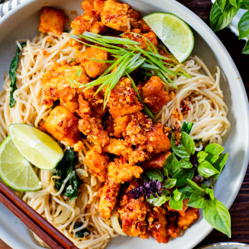 This Chili Crunch Tofu & Spinach Rice Noodles recipe is a better than takeout vegan dinner! Crispy tofu, veggie rice noodles & fresh herbs | ThisSavoryVegan.com