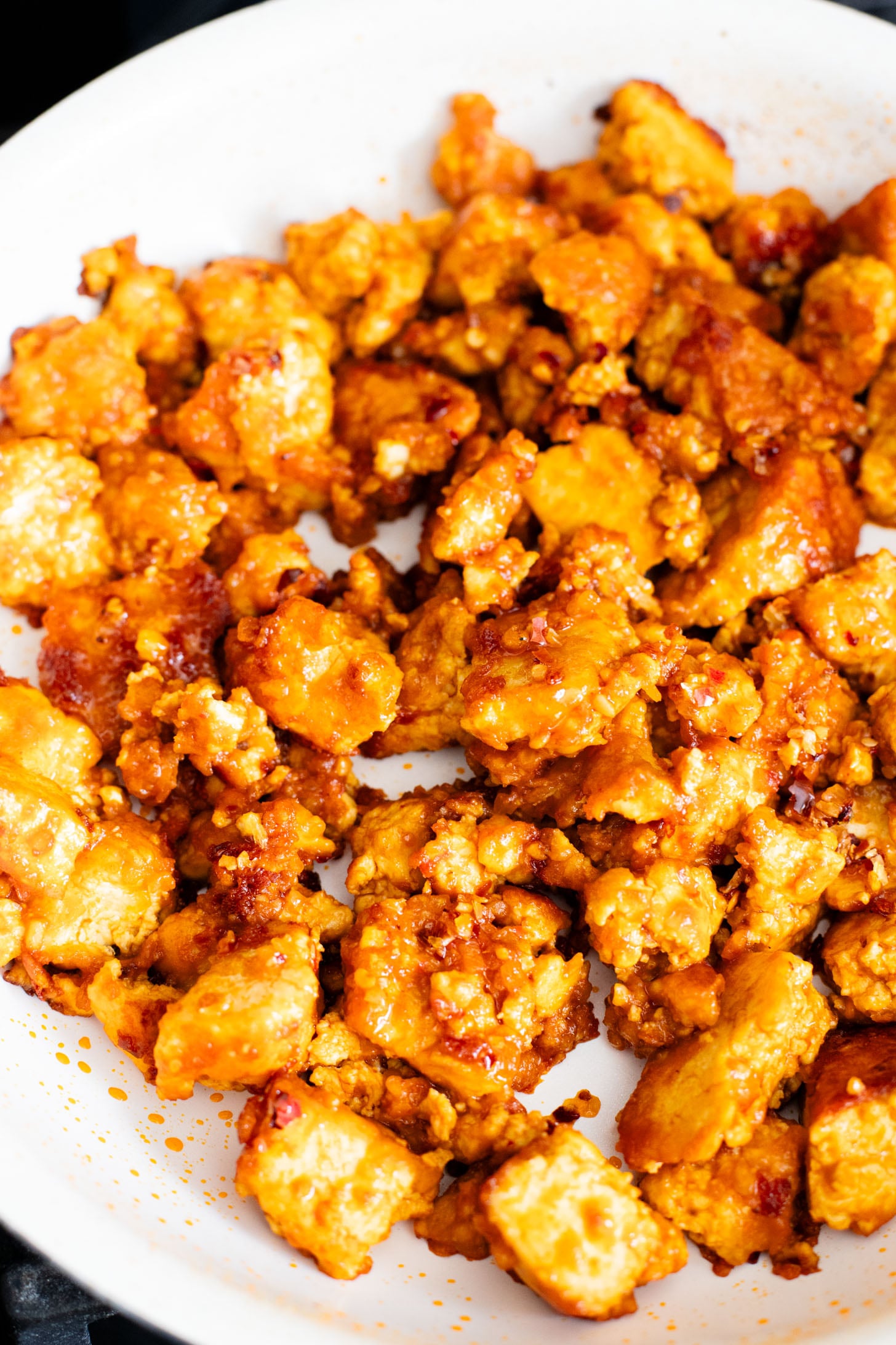 This Chili Crunch Tofu & Spinach Rice Noodles recipe is a better than takeout vegan dinner! Crispy tofu, veggie rice noodles & fresh herbs | ThisSavoryVegan.com