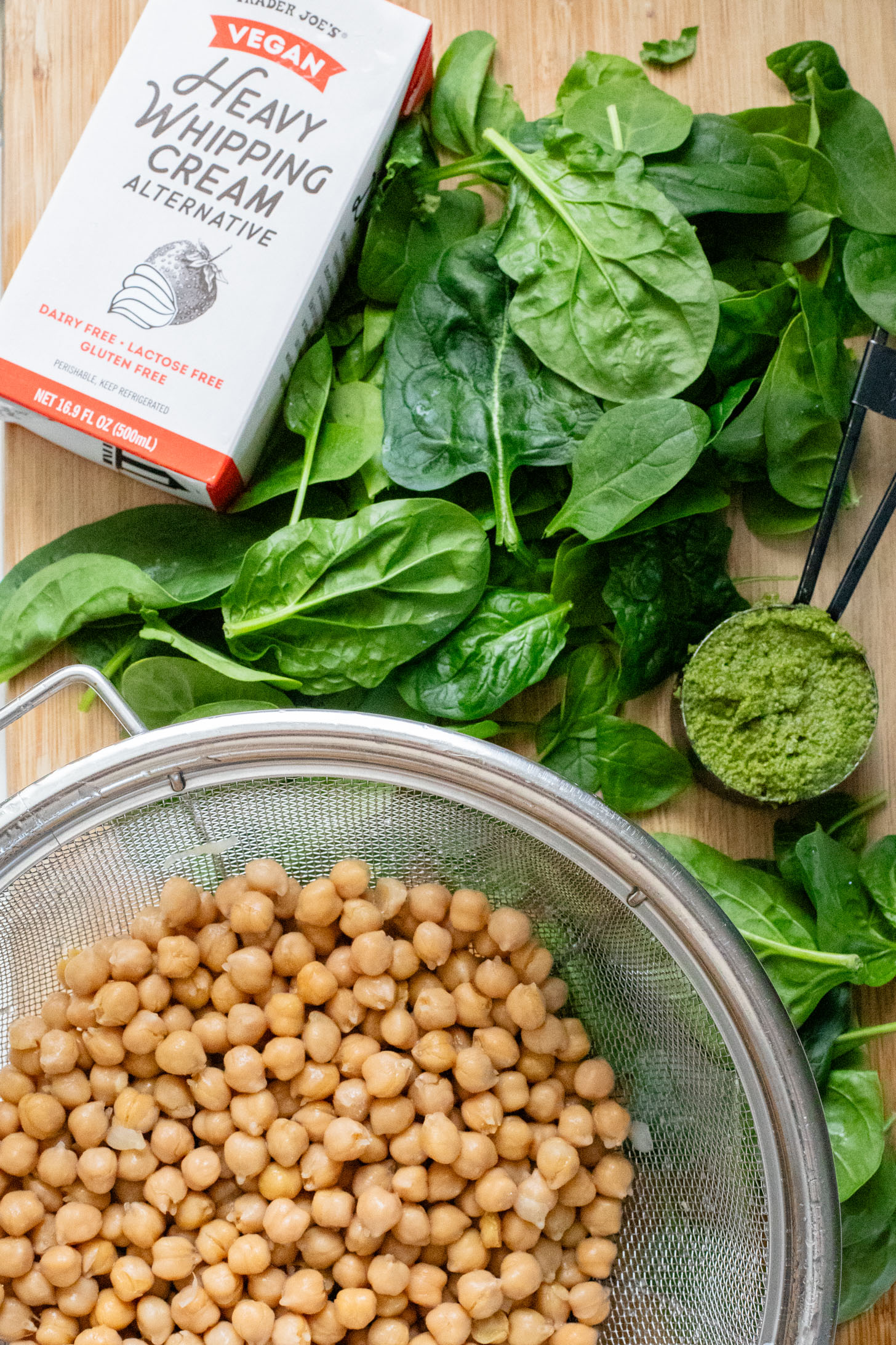 These Creamy Spinach & Pesto Chickpeas are served with lemon parmesan rice. A delicious vegan dinner that takes less than an hour | ThisSavoryVegan.com