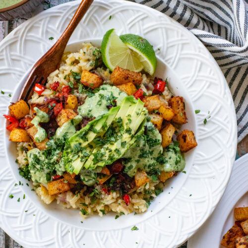 These Crispy Potato & Green Chile Rice Bowls are filled with flavor-packed rice, crispy potatoes, soy chorizo & a cilantro lime sauce | ThisSavoryVegan.com