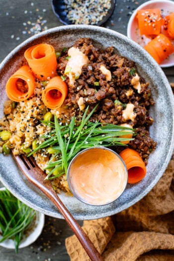 These Ginger Garlic Vegan Beef Bowls are layered with edamame cauliflower rice, saucy vegan beef crumbles and spicy mayo | ThisSavoryVegan.com