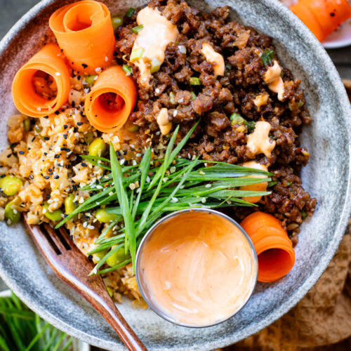 These Ginger Garlic Vegan Beef Bowls are layered with edamame cauliflower rice, saucy vegan beef crumbles and spicy mayo | ThisSavoryVegan.com