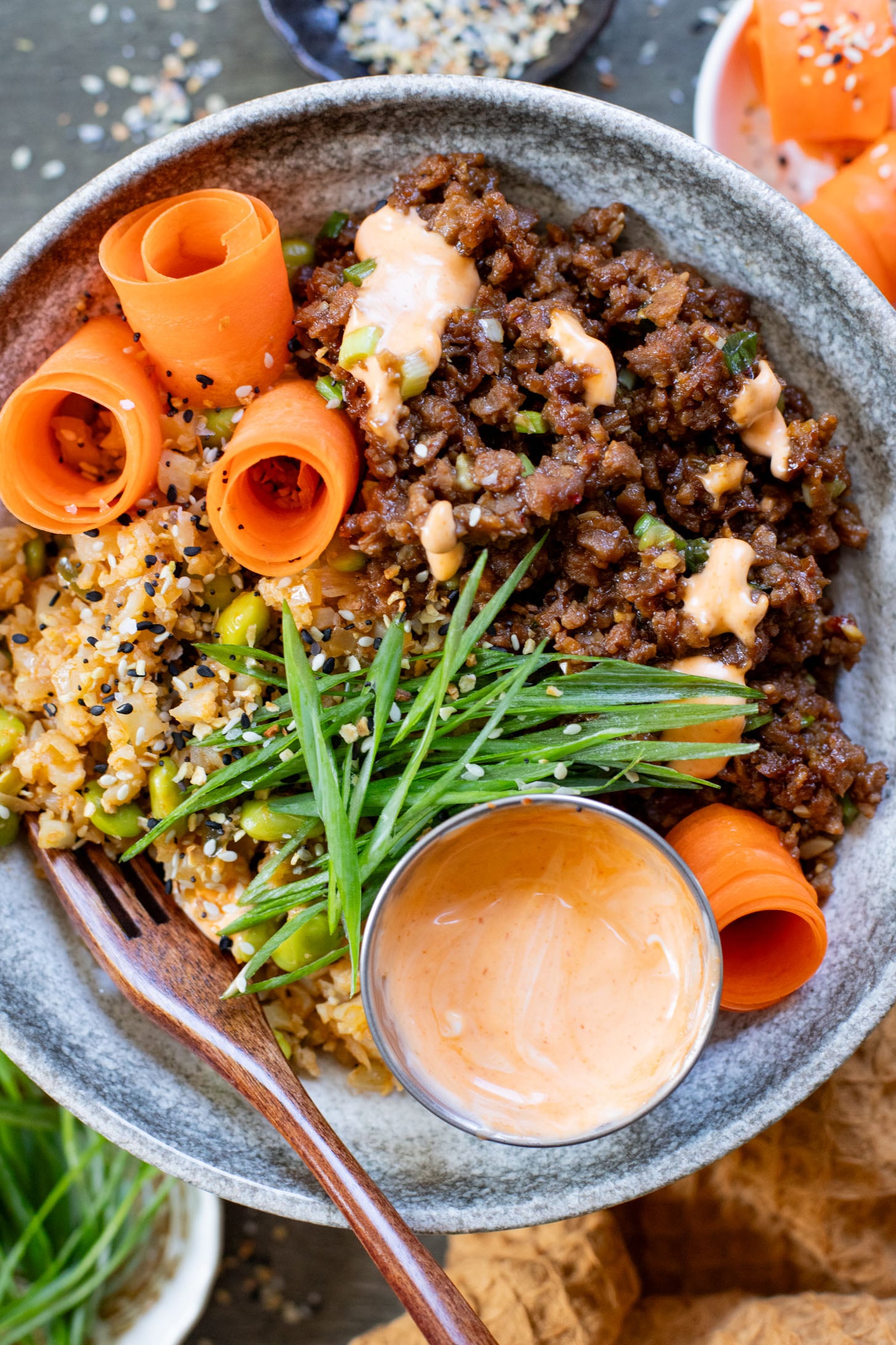 These Ginger Garlic Vegan Beef Bowls are layered with edamame cauliflower rice, saucy vegan beef crumbles and spicy mayo | ThisSavoryVegan.com