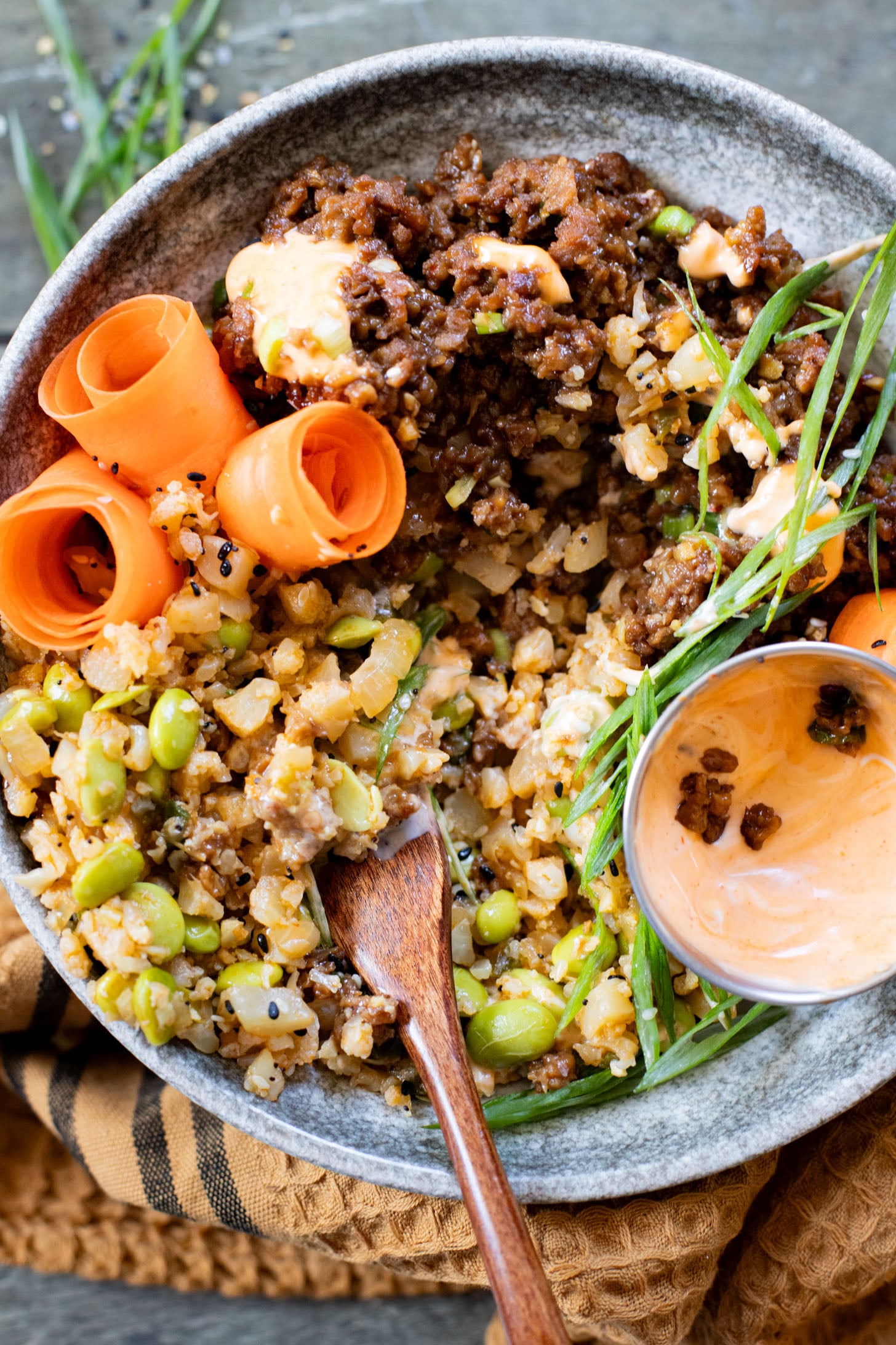 These Ginger Garlic Vegan Beef Bowls are layered with edamame cauliflower rice, saucy vegan beef crumbles and spicy mayo | ThisSavoryVegan.com