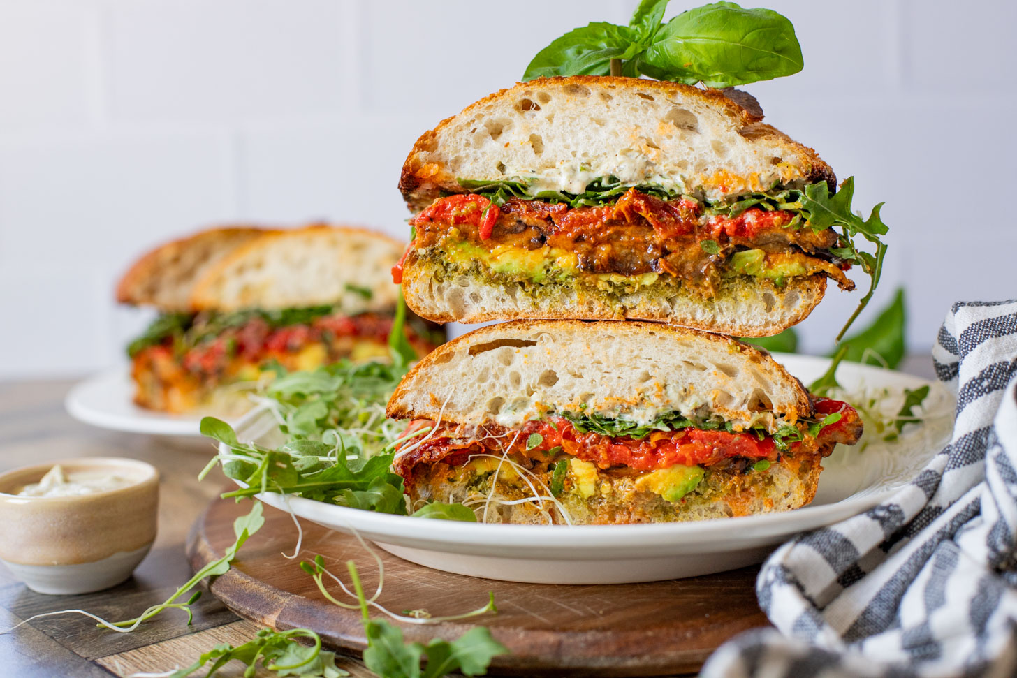 This Harissa Eggplant Picnic Sandwich is perfect for lunch outings. Made with ciabatta and layered with loads of veggies, pesto & tahini sauce | ThisSavoryVegan.com
