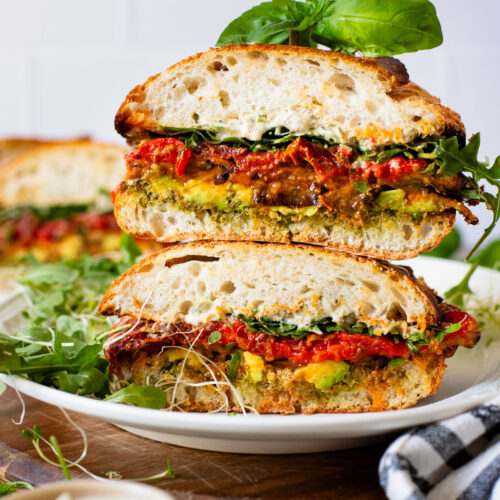 This Harissa Eggplant Picnic Sandwich is perfect for lunch outings. Made with ciabatta and layered with loads of veggies, pesto & tahini sauce | ThisSavoryVegan.com