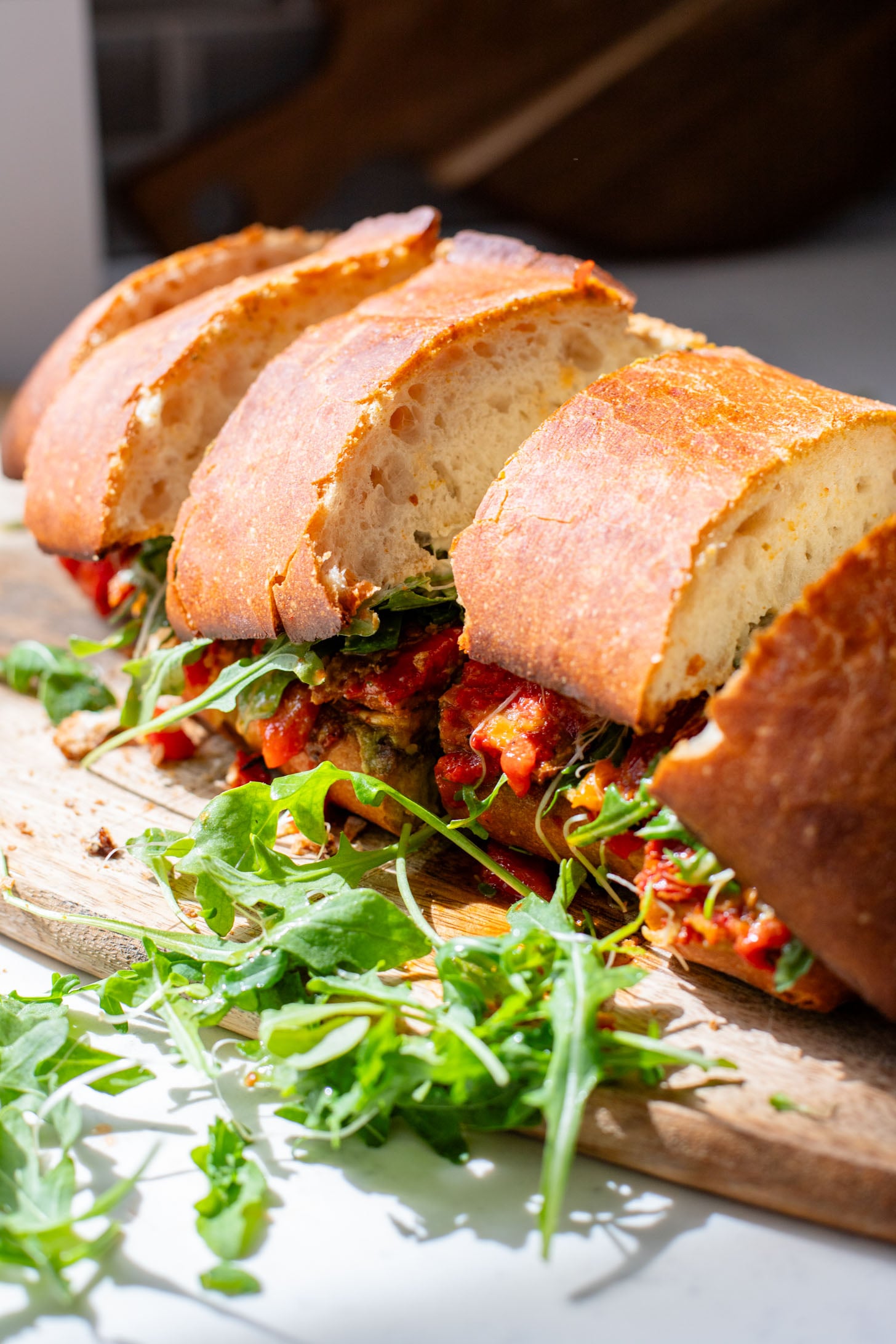 This Harissa Eggplant Picnic Sandwich is perfect for lunch outings. Made with ciabatta and layered with loads of veggies, pesto & tahini sauce | ThisSavoryVegan.com