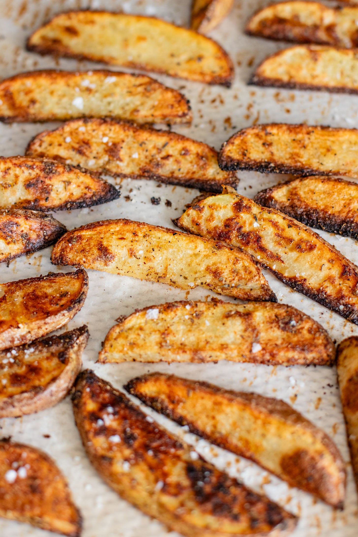 These Loaded Greek Potato Wedges are a great vegan meal idea. Marinated chickpeas, vegan feta, crispy potato wedges & a tahini sauce | ThisSavoryVegan.com