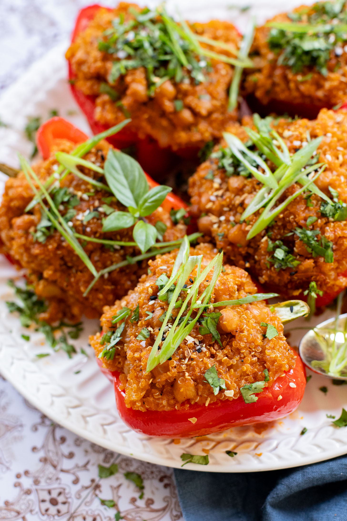 These Red Curry Quinoa Stuffed Peppers are Thai-inspired with quinoa & chickpeas cooked in a coconut red curry sauce & baked in bell peppers | ThisSavoryVegan.com