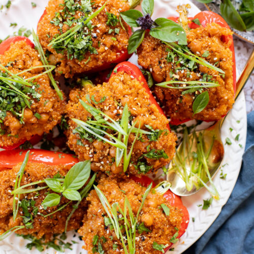 These Red Curry Quinoa Stuffed Peppers are Thai-inspired with quinoa & chickpeas cooked in a coconut red curry sauce & baked in bell peppers | ThisSavoryVegan.com