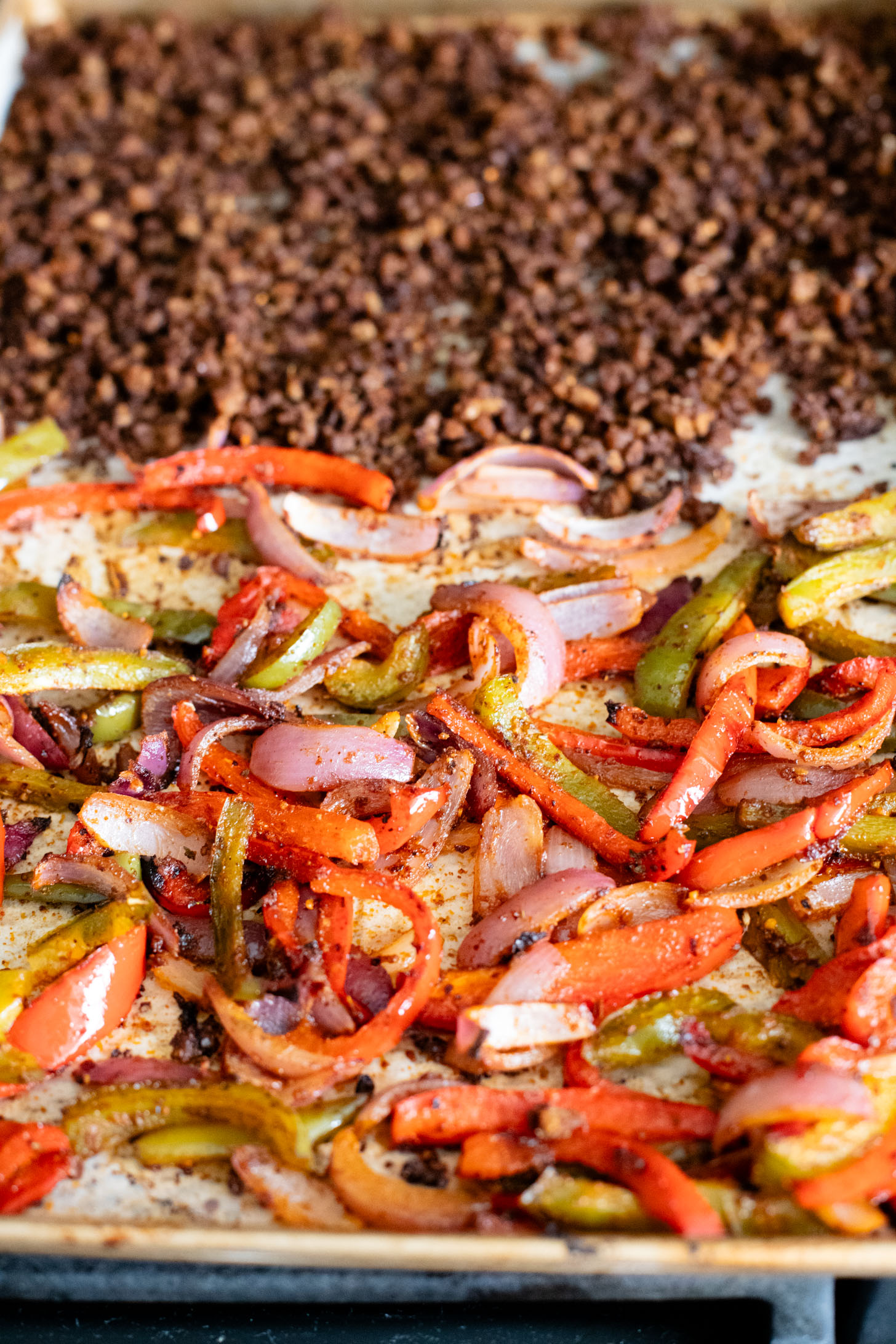 A quick & easy vegan dinner idea, these Sheet Pan Burrito Bowls are filled with vegan "beef" crumbles, fajita veggies & a cilantro yogurt sauce | ThisSavoryVegan.com