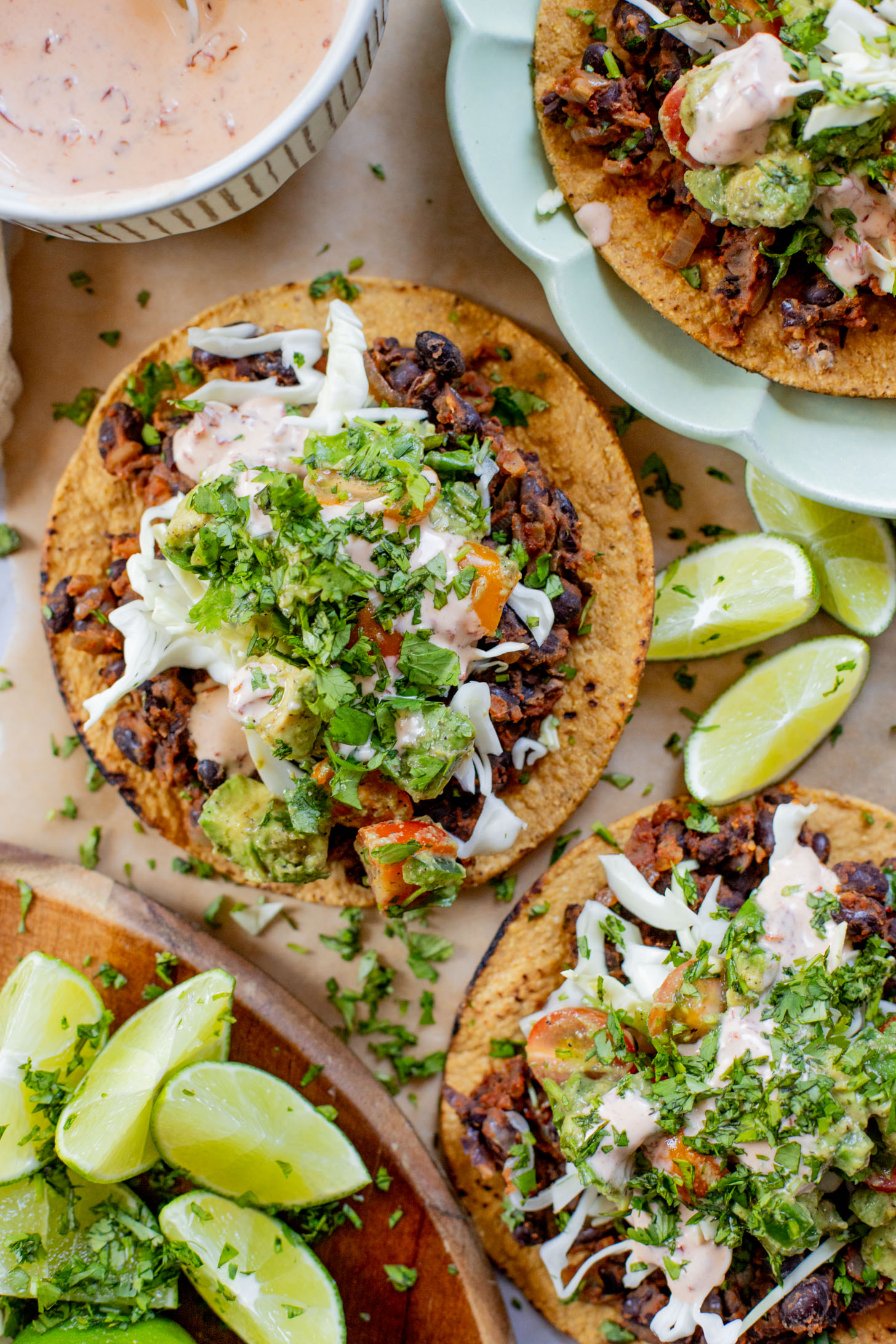 Quick & easy, these Simple Black Bean Tostadas are 100% vegan! Topped with a chunky avocado salsa and chipotle mayo | ThisSavoryVegan.com