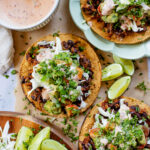 Quick & easy, these Simple Black Bean Tostadas are 100% vegan! Topped with a chunky avocado salsa and chipotle mayo | ThisSavoryVegan.com