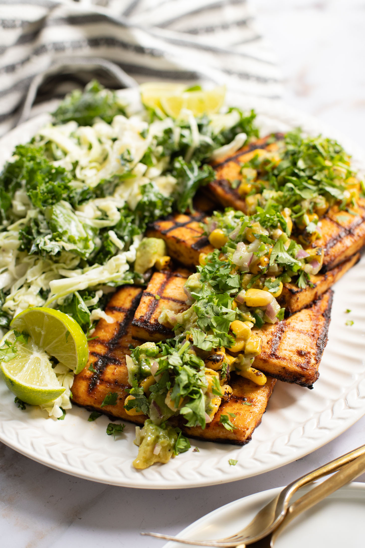 Get ready for grilling season with these Chipotle Tofu Steaks with Avocado Corn Salsa - made with Nasoya's Super Firm Tofu and grilled until crispy | ThisSavoryVegan.com
