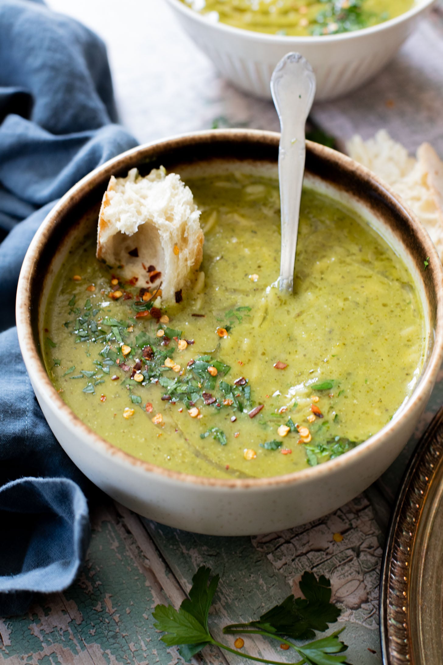 This Creamy Zucchini Pesto Soup is 100% dairy-free! A creamy pesto, & zucchini base is mixed with orzo for the perfect bite | ThisSavoryVegan.com