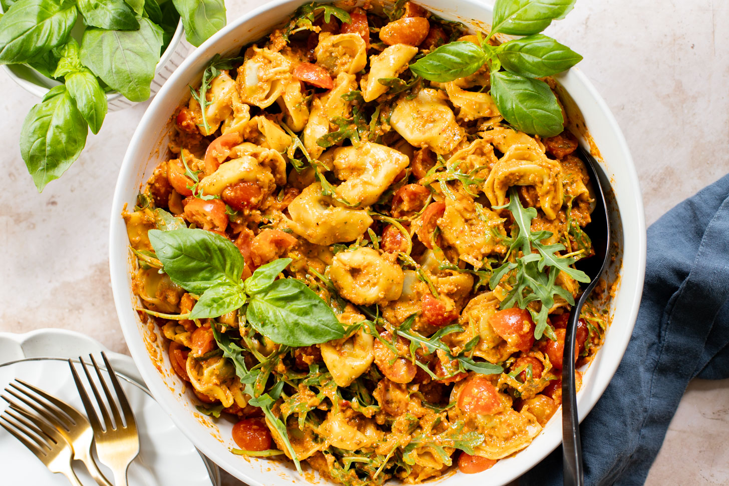 This Pesto Tortellini Pasta Salad is made with a vegan red pepper pesto, tomatoes & arugula. A great vegan side dish for a BBQ | ThisSavoryVegan.com