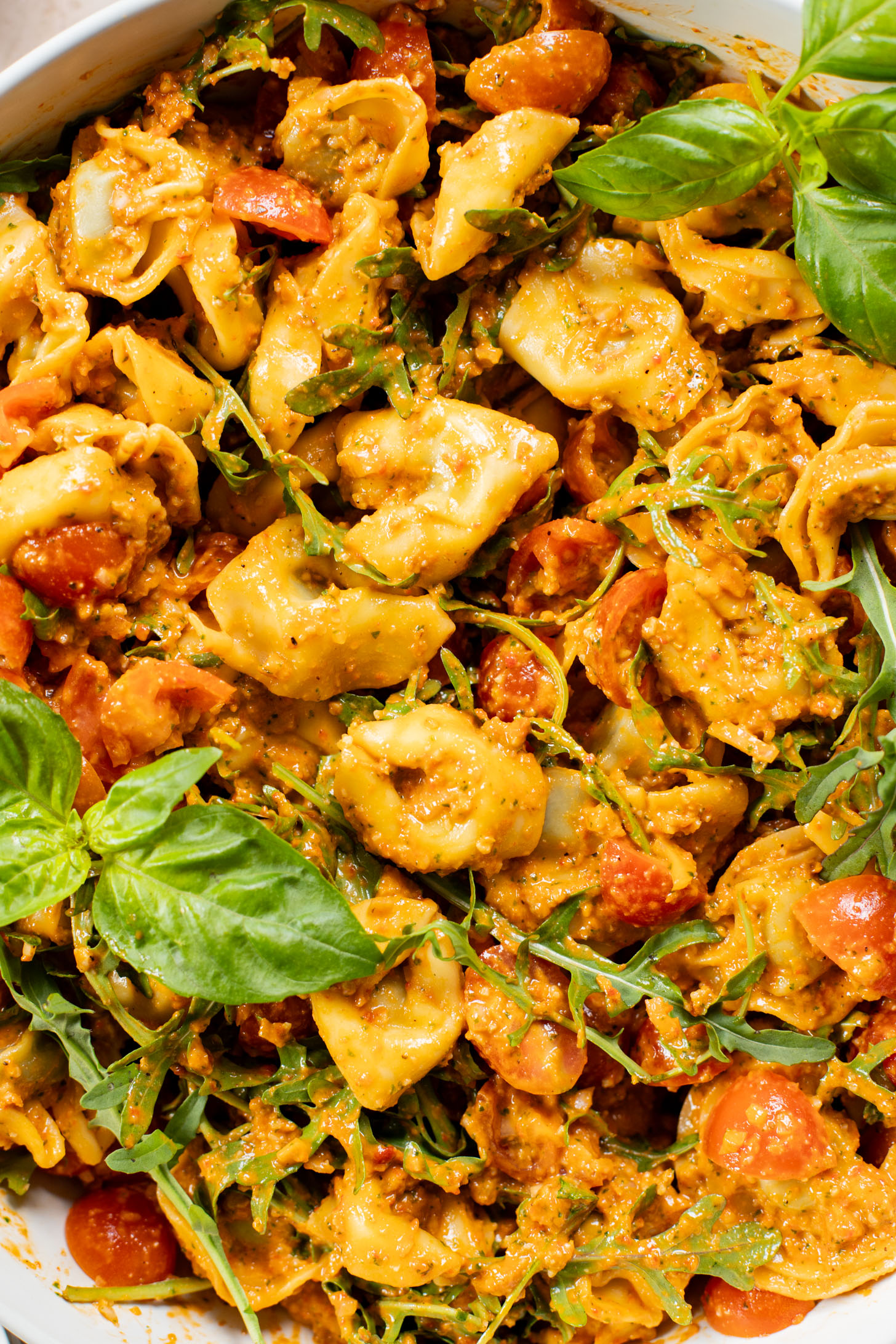 This Pesto Tortellini Pasta Salad is made with a vegan red pepper pesto, tomatoes & arugula. A great vegan side dish for a BBQ | ThisSavoryVegan.com
