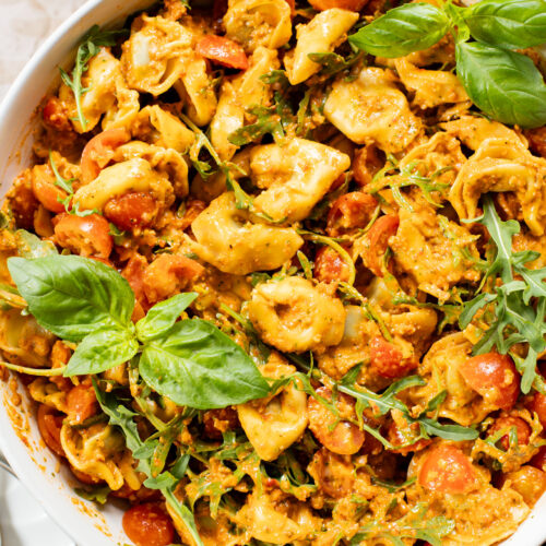 This Pesto Tortellini Pasta Salad is made with a vegan red pepper pesto, tomatoes & arugula. A great vegan side dish for a BBQ | ThisSavoryVegan.com