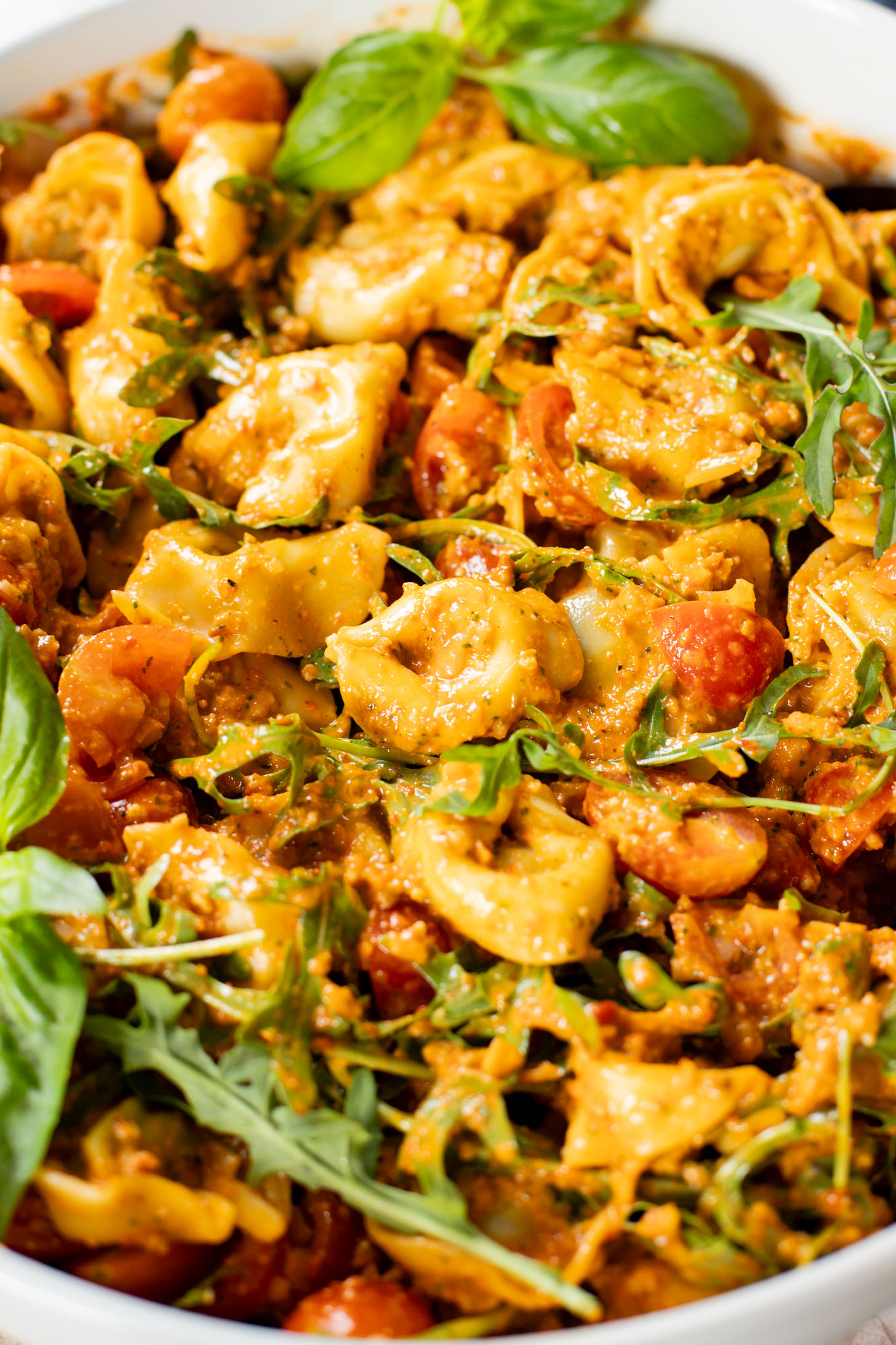 This Pesto Tortellini Pasta Salad is made with a vegan red pepper pesto, tomatoes & arugula. A great vegan side dish for a BBQ | ThisSavoryVegan.com