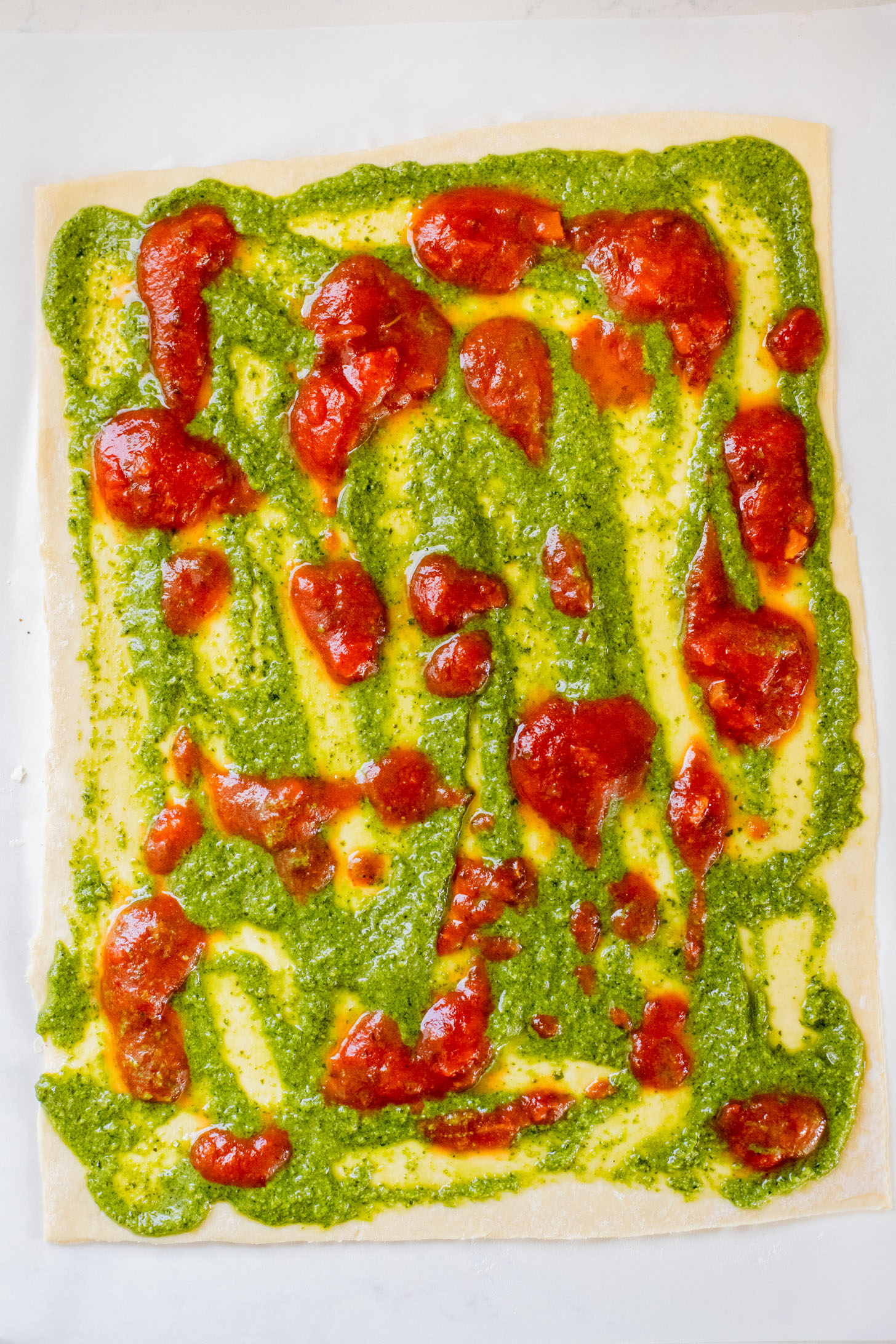 These Puff Pastry Pesto Pizza Bites are the best vegan appetizer. Layers of pizza toppings on puff pastry that is baked until golden | ThisSavoryVegan.com