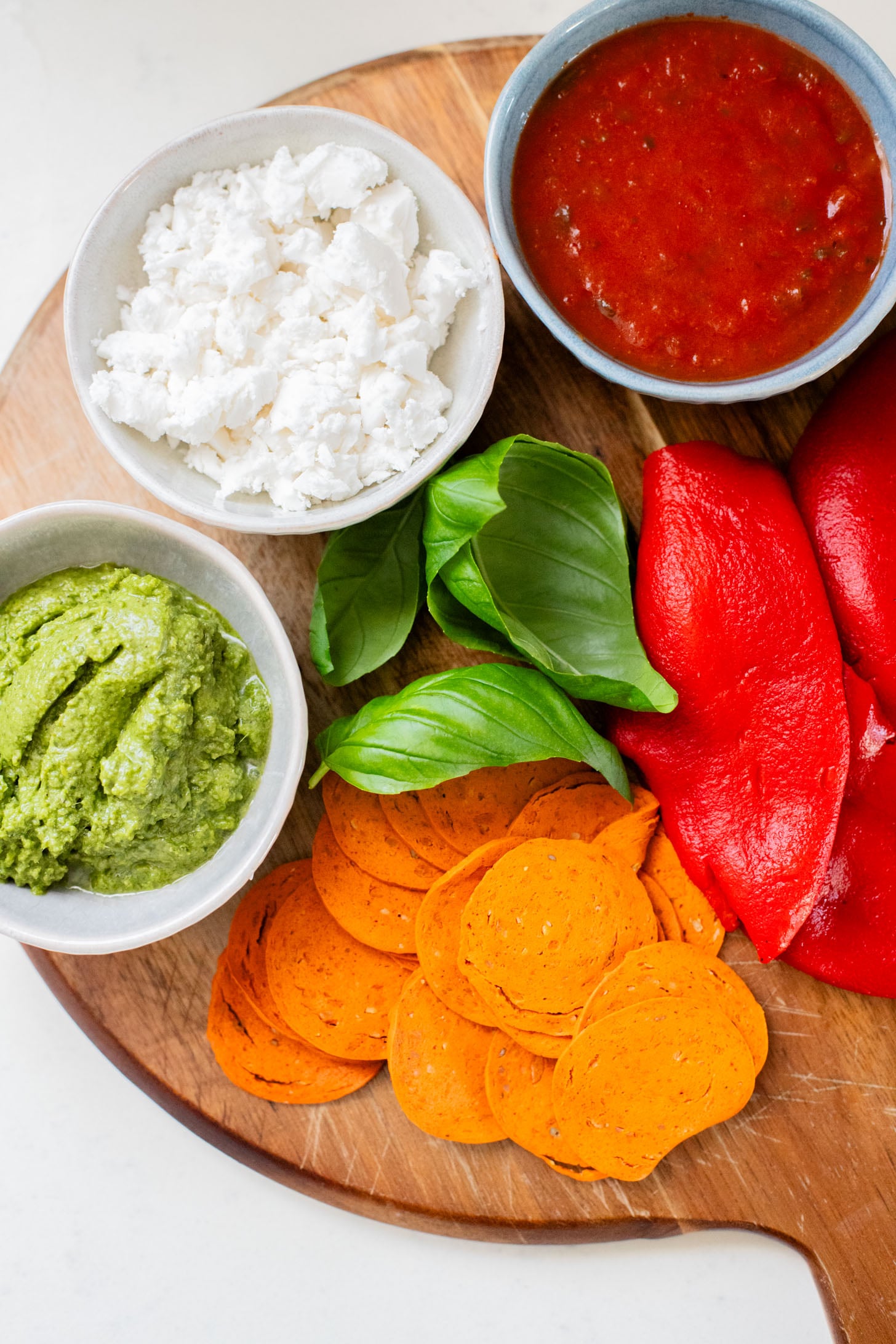 These Puff Pastry Pesto Pizza Bites are the best vegan appetizer. Layers of pizza toppings on puff pastry that is baked until golden | ThisSavoryVegan.com