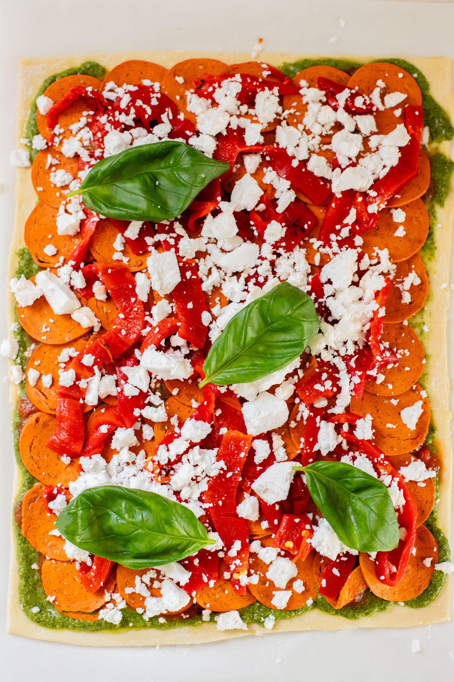 These Puff Pastry Pesto Pizza Bites are the best vegan appetizer. Layers of pizza toppings on puff pastry that is baked until golden | ThisSavoryVegan.com