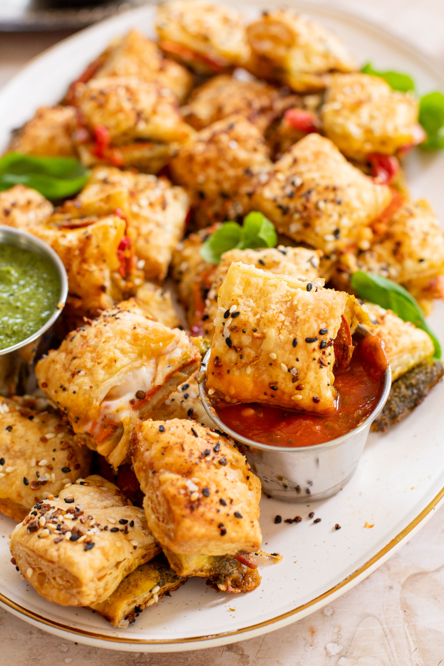 These Puff Pastry Pesto Pizza Bites are the best vegan appetizer. Layers of pizza toppings on puff pastry that is baked until golden | ThisSavoryVegan.com