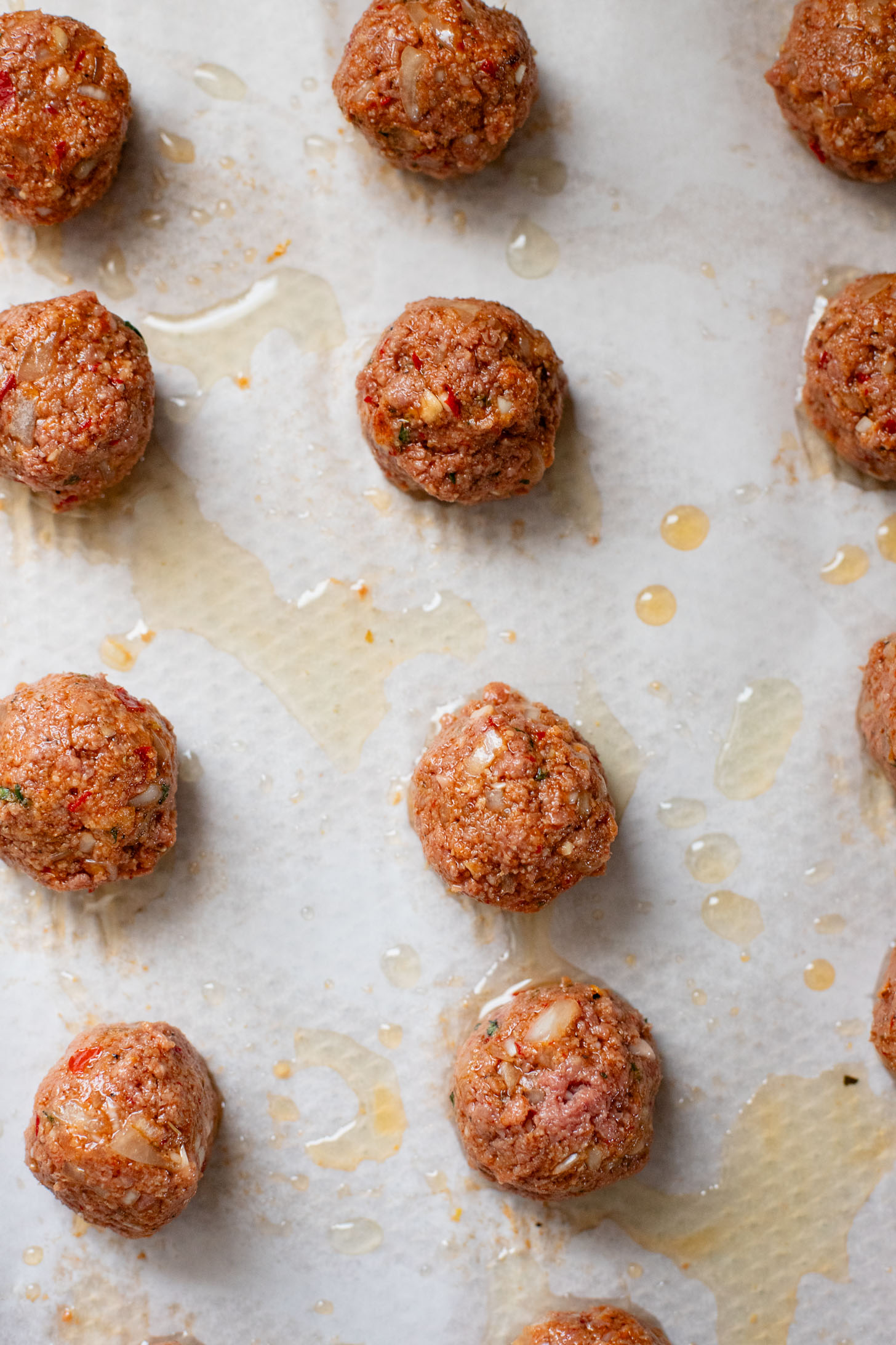These Sheet Pan Vegan Harissa Meatballs are a high protein vegan meal idea. Served with roasted zucchini, chickpeas and avocado dressing | ThisSavoryVegan.com