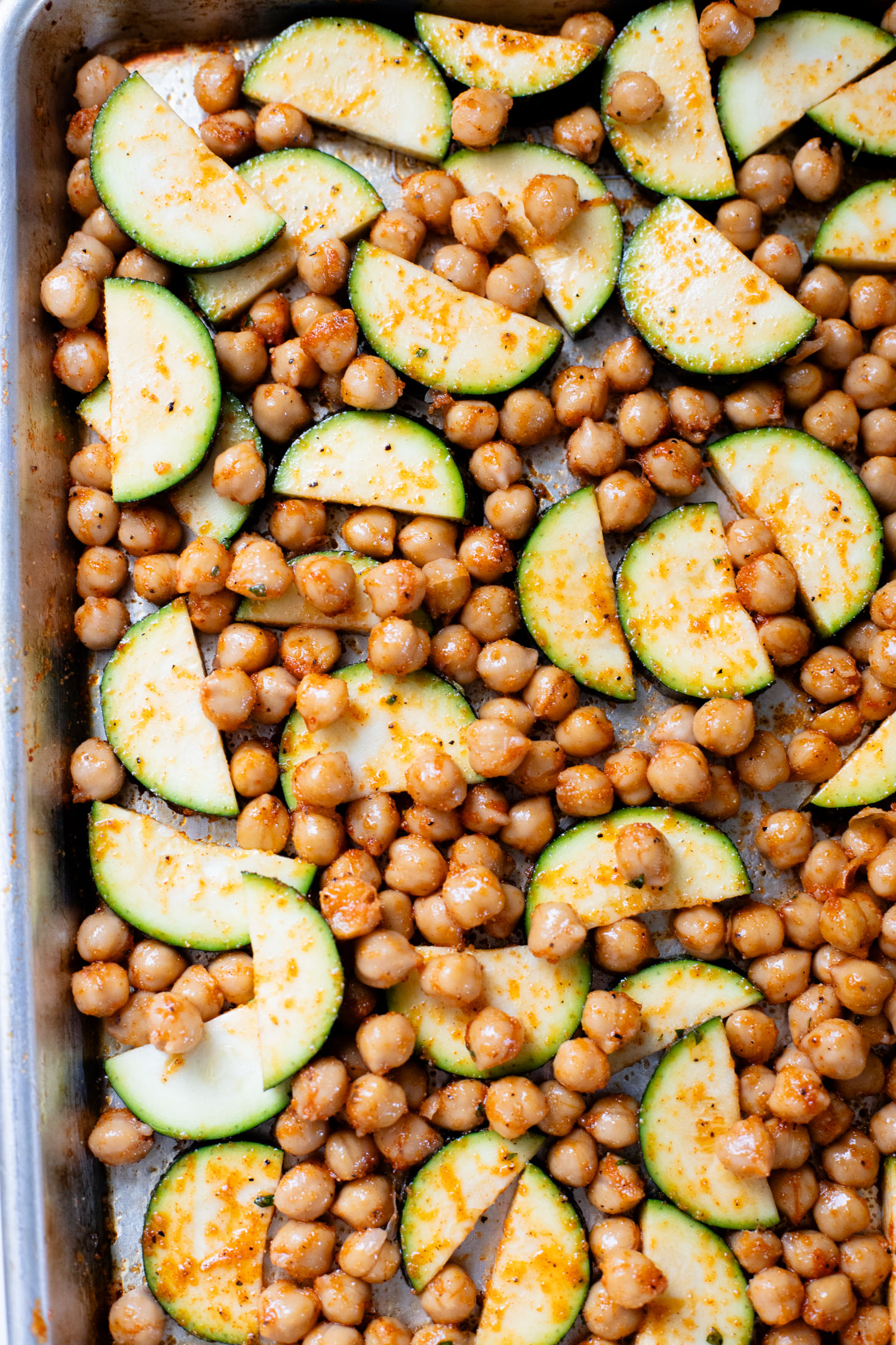 These Sheet Pan Vegan Harissa Meatballs are a high protein vegan meal idea. Served with roasted zucchini, chickpeas and avocado dressing | ThisSavoryVegan.com