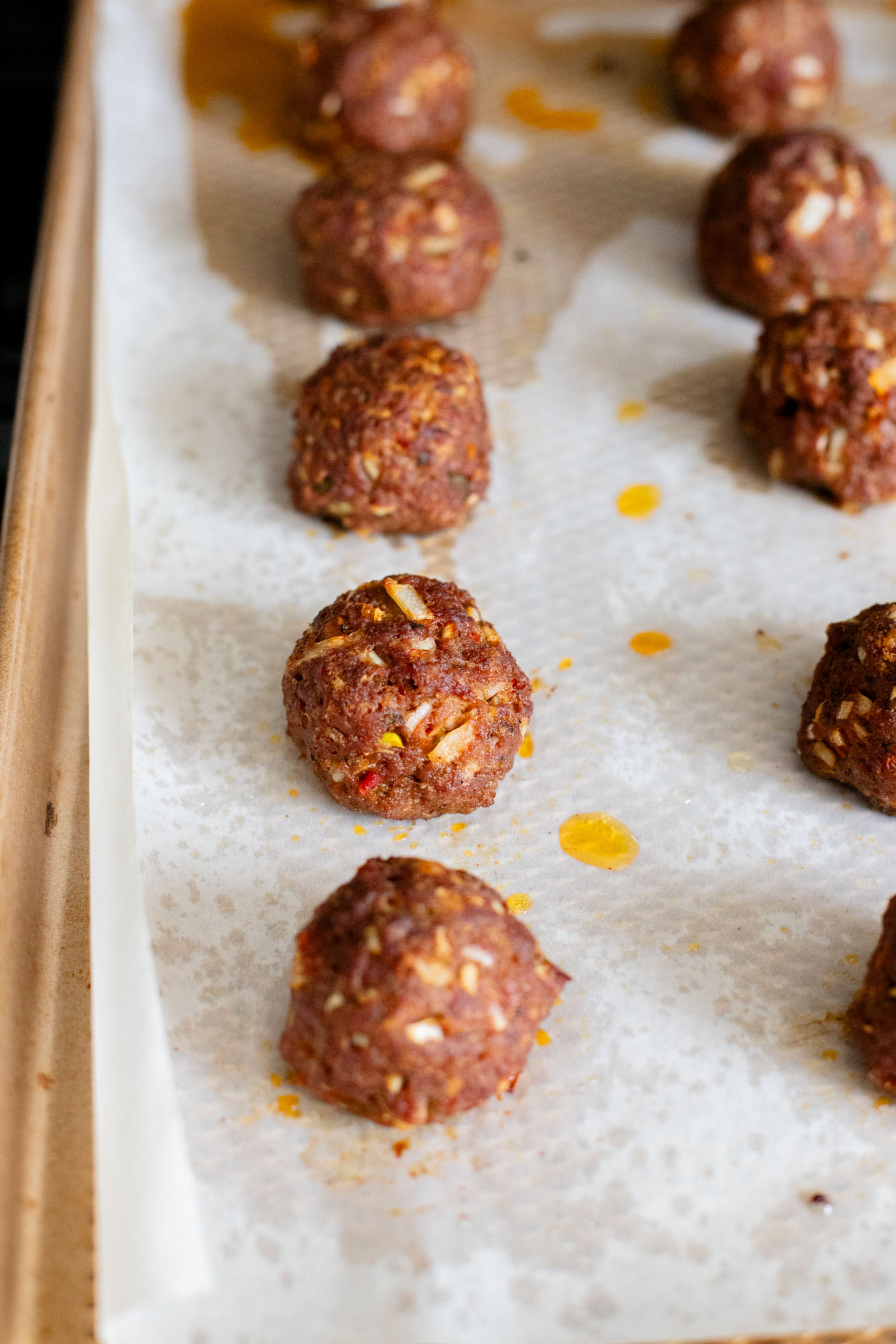 These Sheet Pan Vegan Harissa Meatballs are a high protein vegan meal idea. Served with roasted zucchini, chickpeas and avocado dressing | ThisSavoryVegan.com