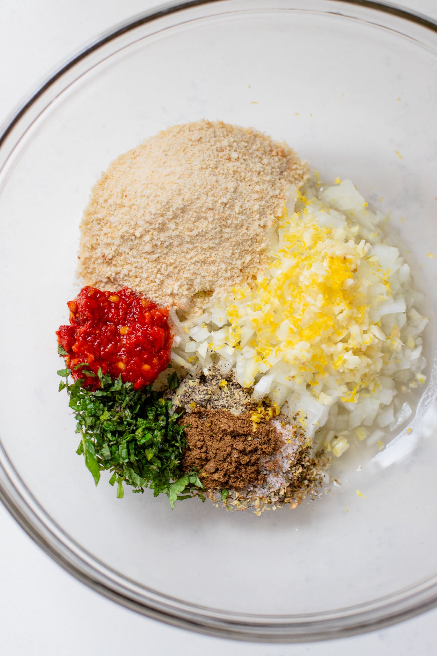 These Sheet Pan Vegan Harissa Meatballs are a high protein vegan meal idea. Served with roasted zucchini, chickpeas and avocado dressing | ThisSavoryVegan.com