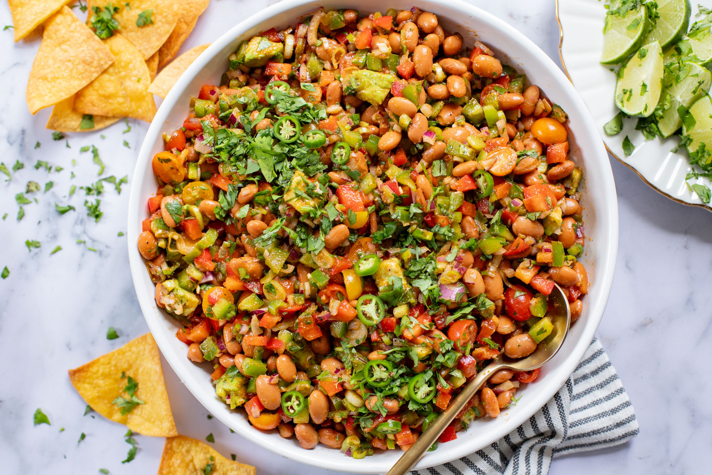 This Simple Pinto Bean Salad is a mix of canned beans, crunchy veggies, avocado chunks and a chipotle chili lime dressing | ThisSavoryVegan.com