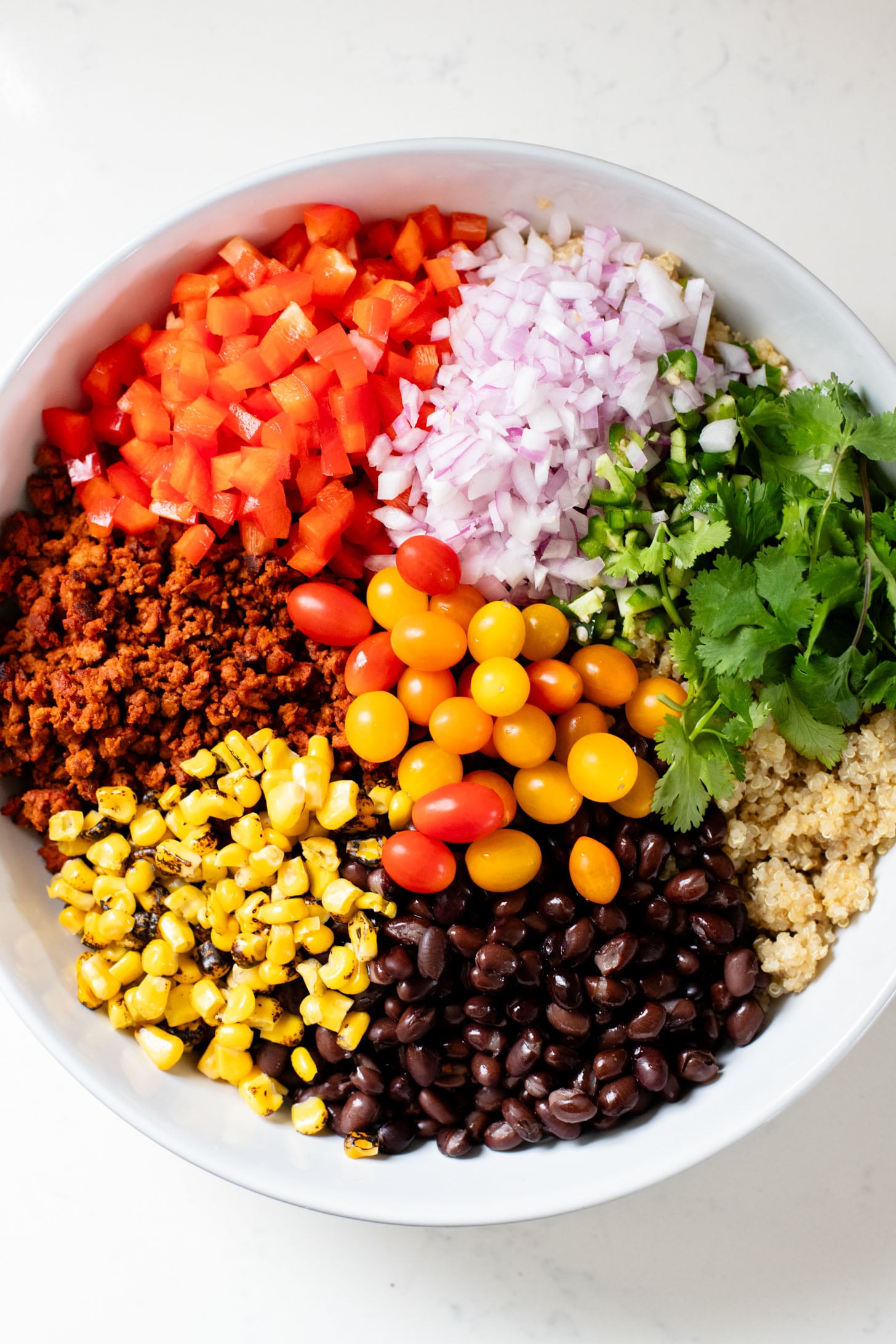 This Southwest Quinoa Salad is perfect for meal prep or a party. Packed with plant protein, plenty of veggies and a creamy sauce | ThisSavoryVegan.com