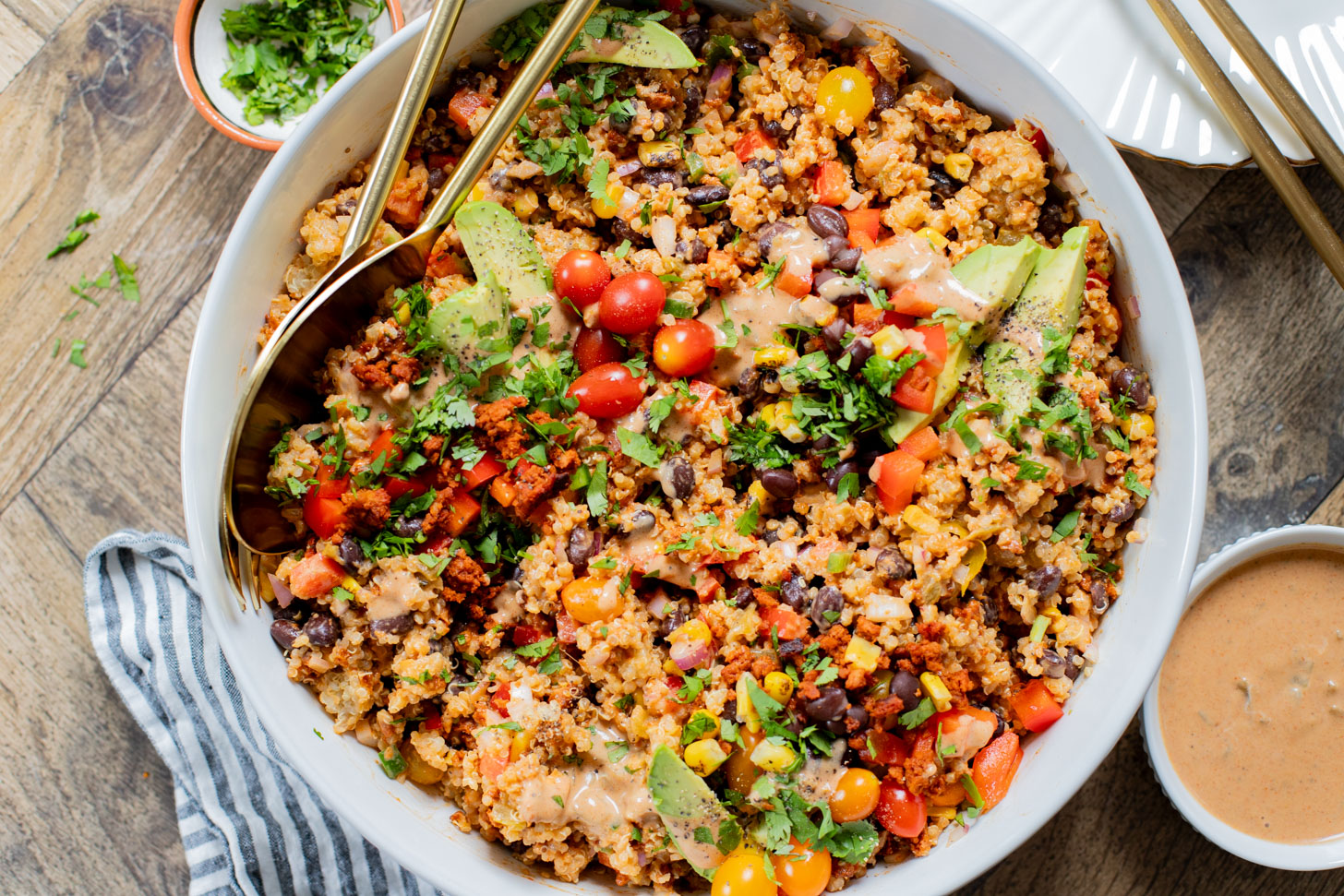 This Southwest Quinoa Salad is perfect for meal prep or a party. Packed with plant protein, plenty of veggies and a creamy sauce | ThisSavoryVegan.com