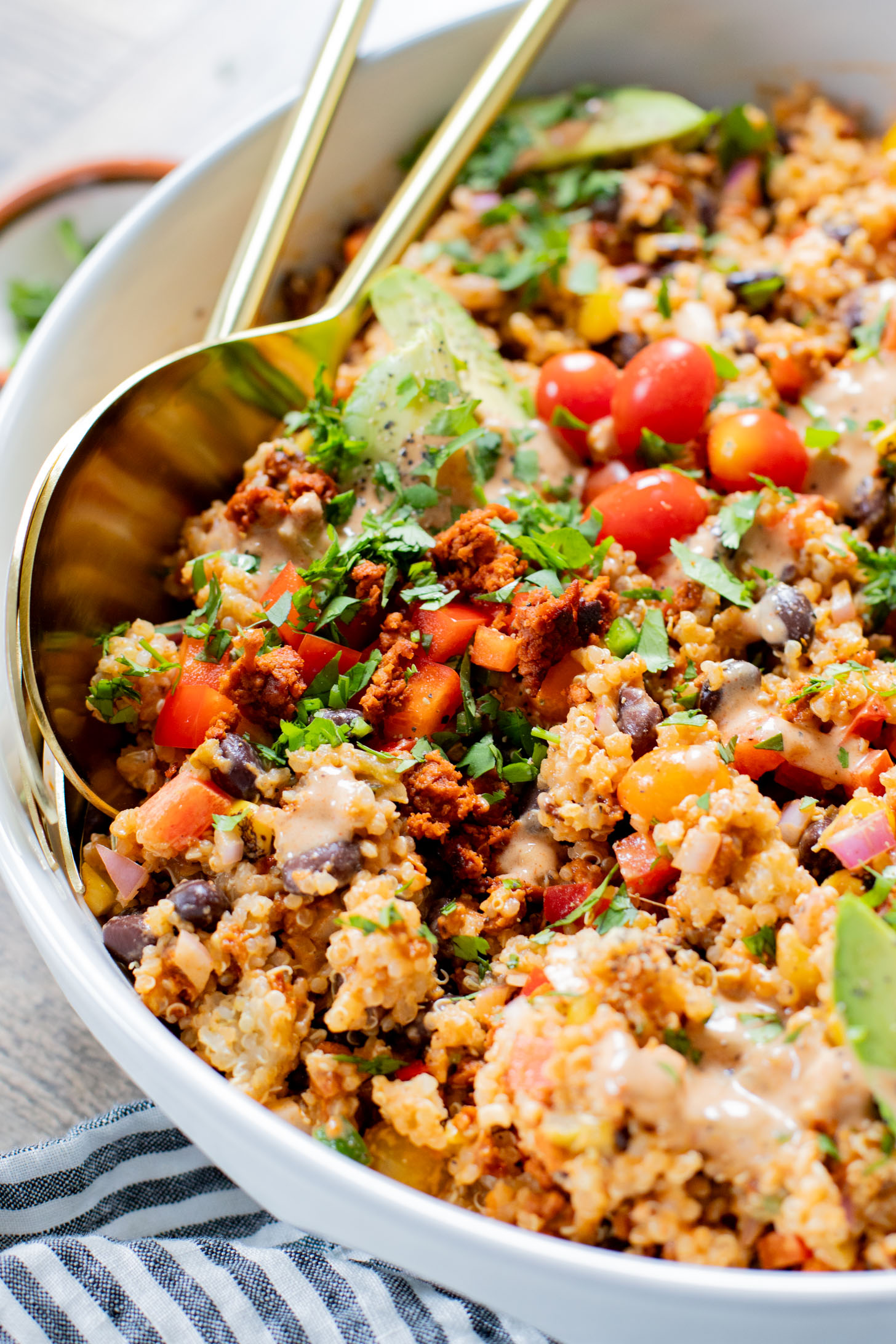 This Southwest Quinoa Salad is perfect for meal prep or a party. Packed with plant protein, plenty of veggies and a creamy sauce | ThisSavoryVegan.com