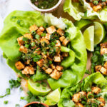 Layered with crispy peanut tofu, a spicy asian sauce and plenty of fresh herbs, these Tofu Lettuce Wraps are bright, easy and filling | ThisSavoryVegan.com