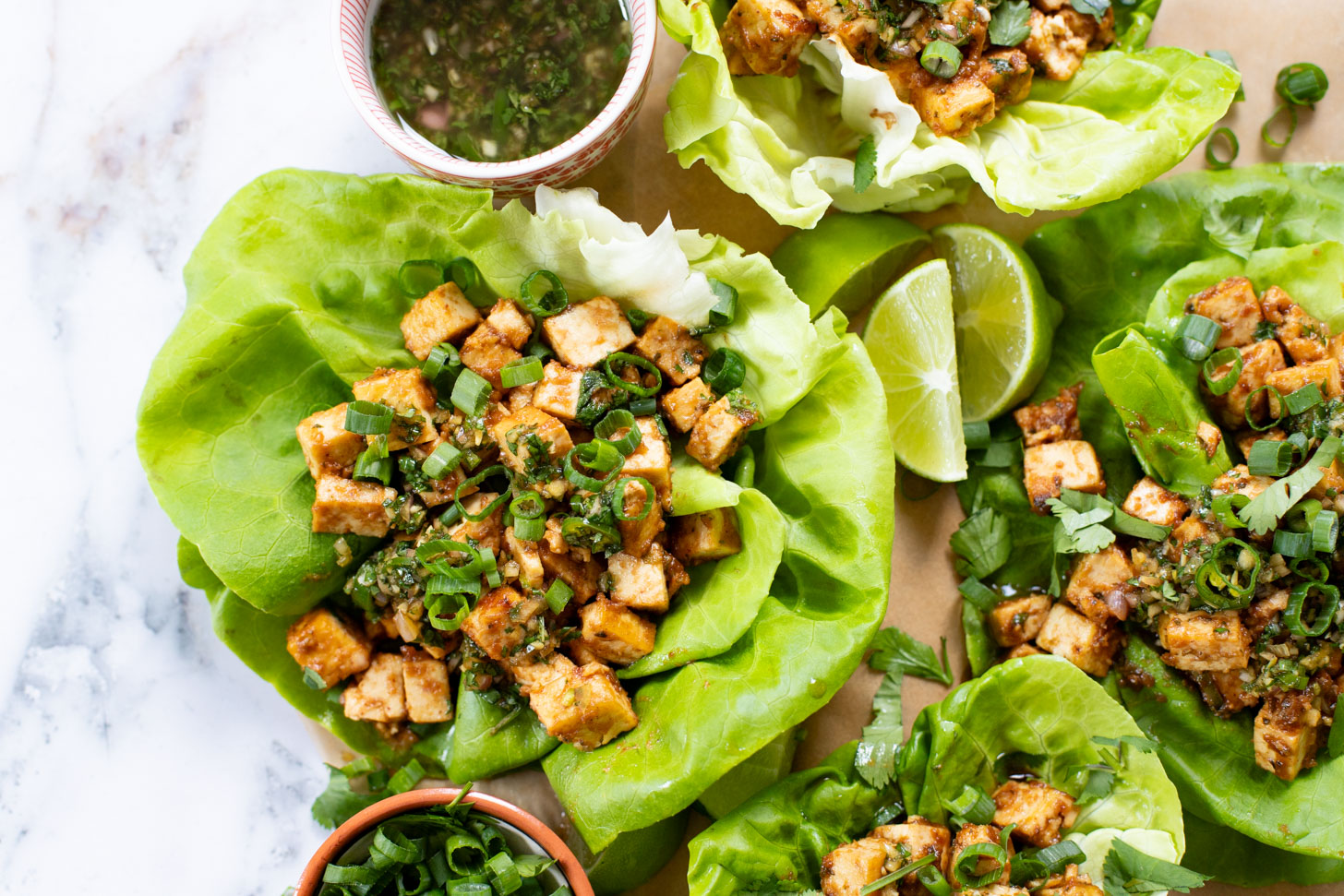 Layered with crispy peanut tofu, a spicy asian sauce and plenty of fresh herbs, these Tofu Lettuce Wraps are bright, easy and filling | ThisSavoryVegan.com