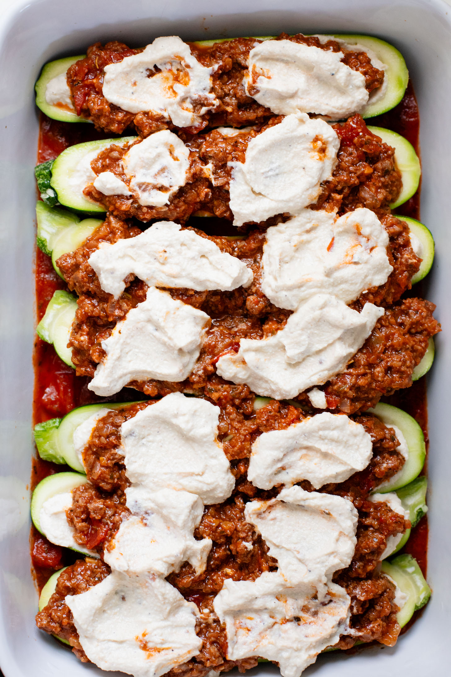 These Vegan Lasagna Zucchini Boats are a low-carb, dairy-free way to enjoy your favorite lasagna flavors! Served with an oil-free pesto | ThisSavoryVegan.com