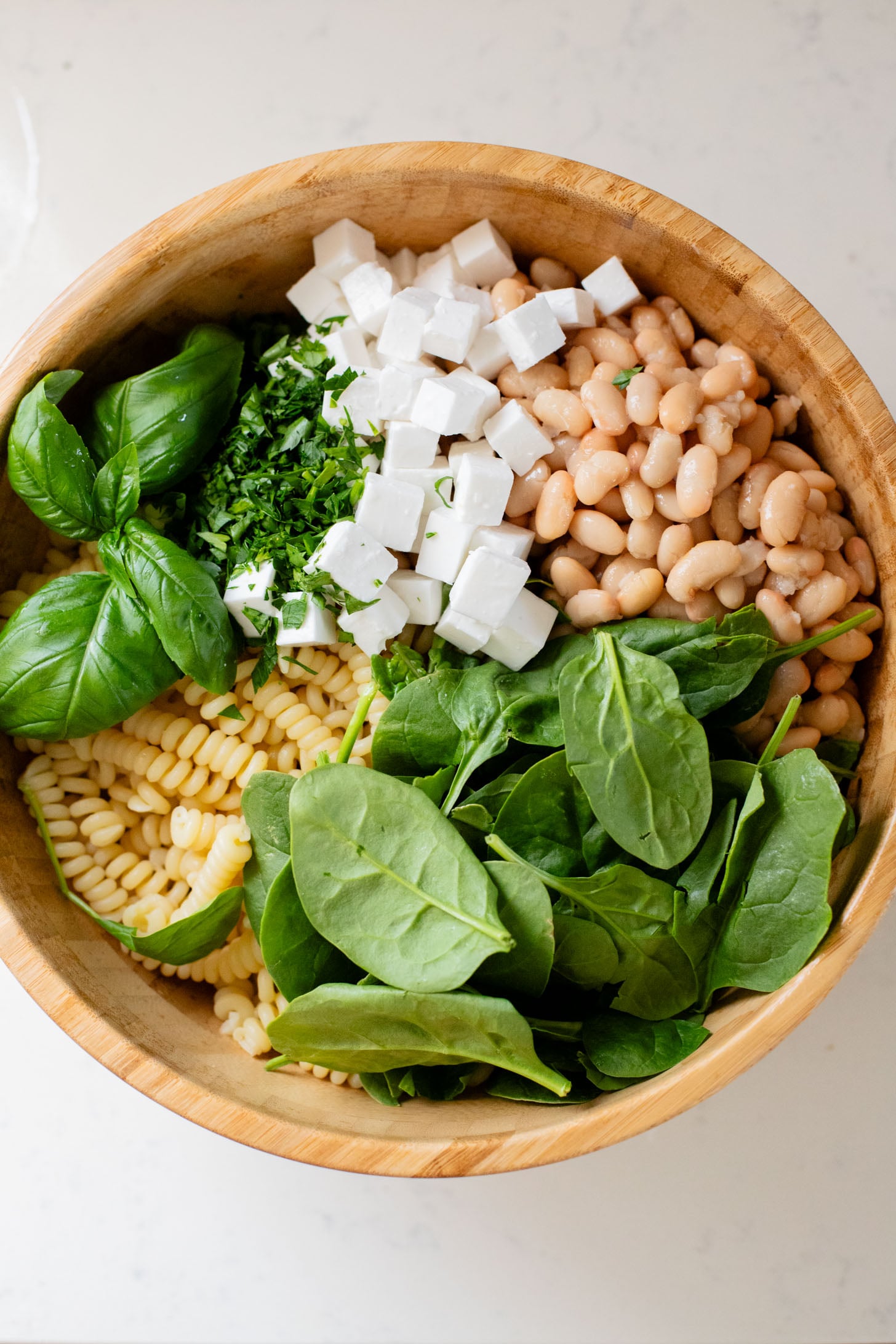 This White Bean Balsamic Pasta Salad is a summer must make! Made with vegan feta, cherry tomatoes, herbs, white beans & balsamic dressing | ThisSavoryVegan.com