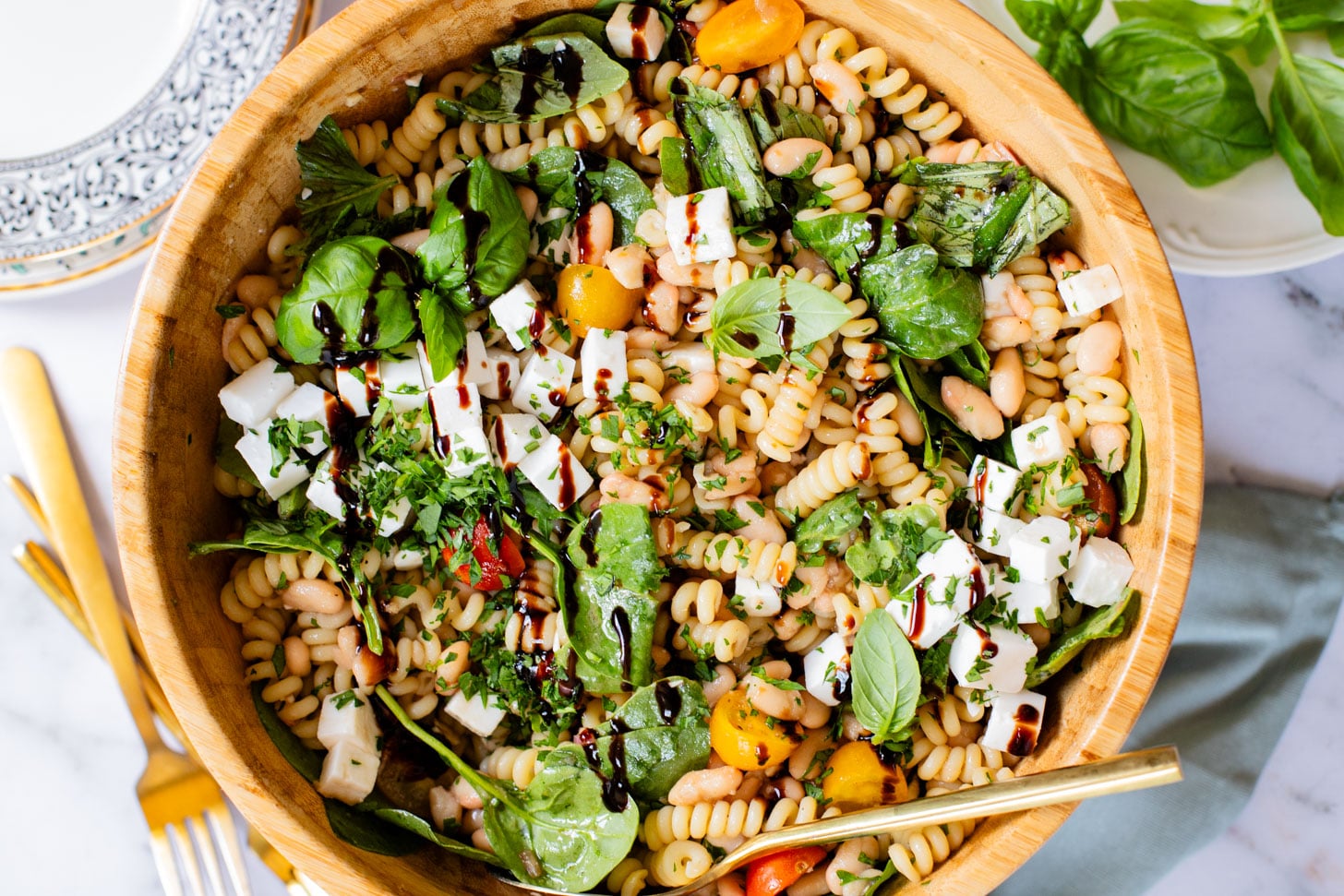 This White Bean Balsamic Pasta Salad is a summer must make! Made with vegan feta, cherry tomatoes, herbs, white beans & balsamic dressing | ThisSavoryVegan.com