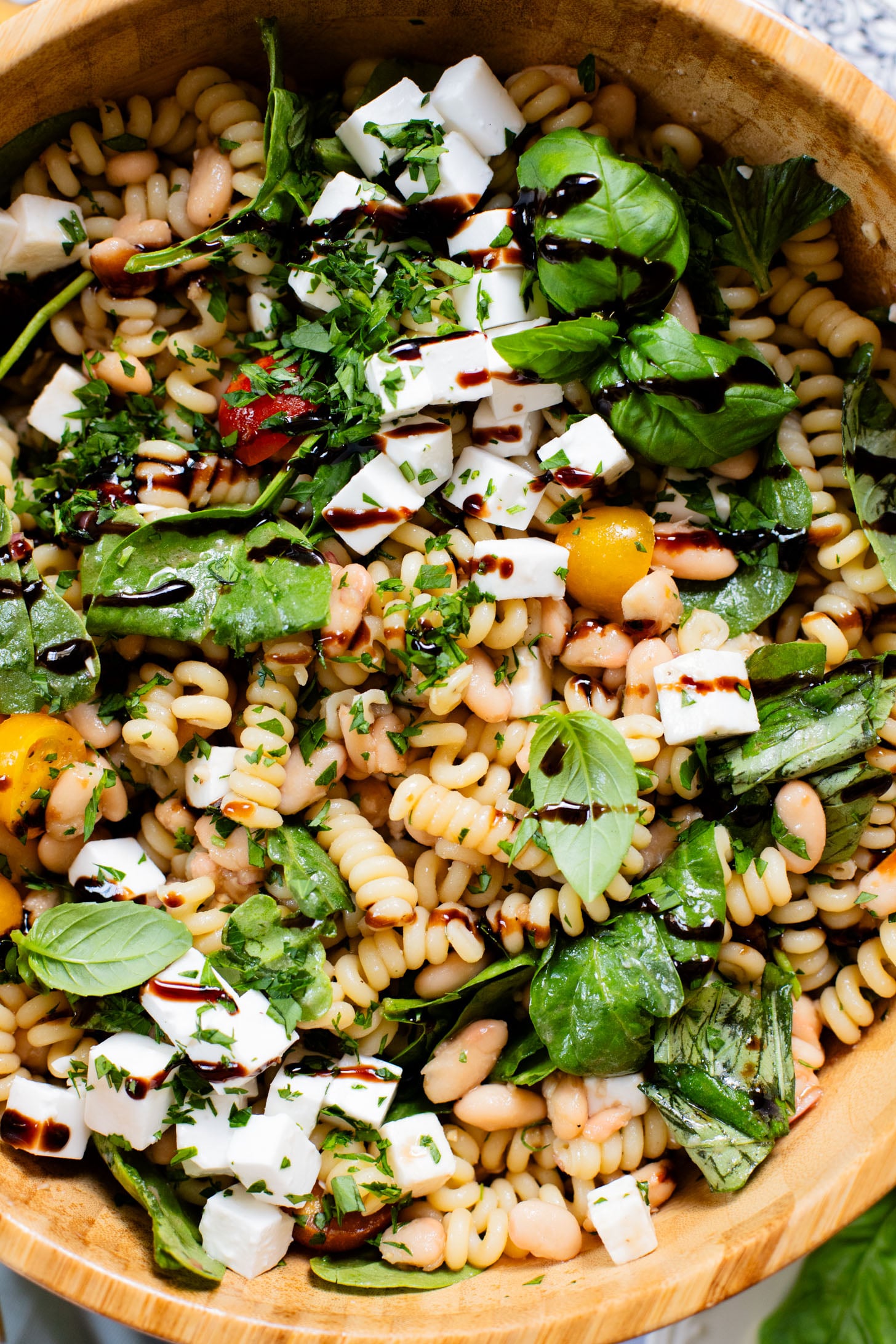 This White Bean Balsamic Pasta Salad is a summer must make! Made with vegan feta, cherry tomatoes, herbs, white beans & balsamic dressing | ThisSavoryVegan.com